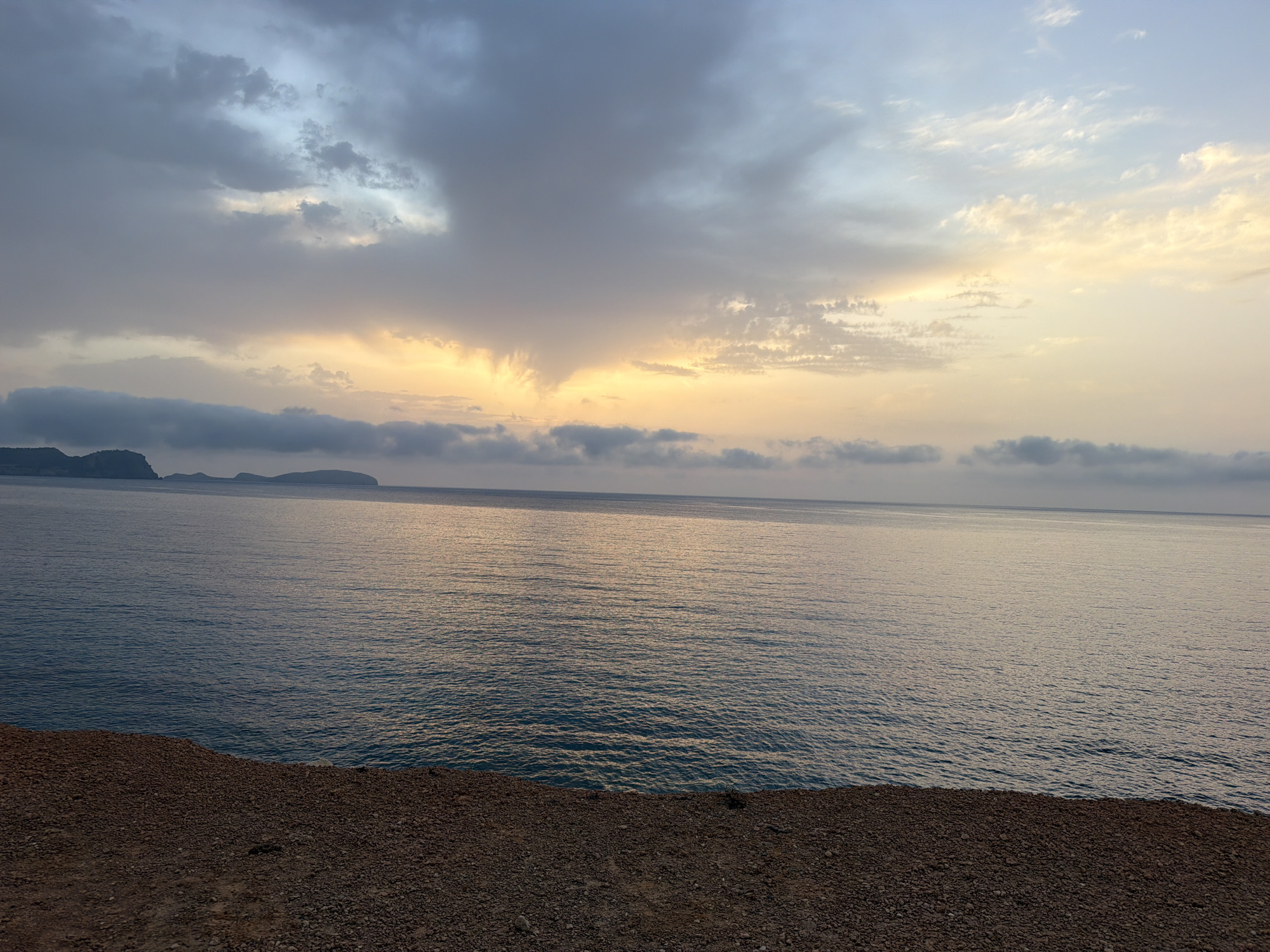 Golden sunset over calm Mediterranean waters off Es Canar