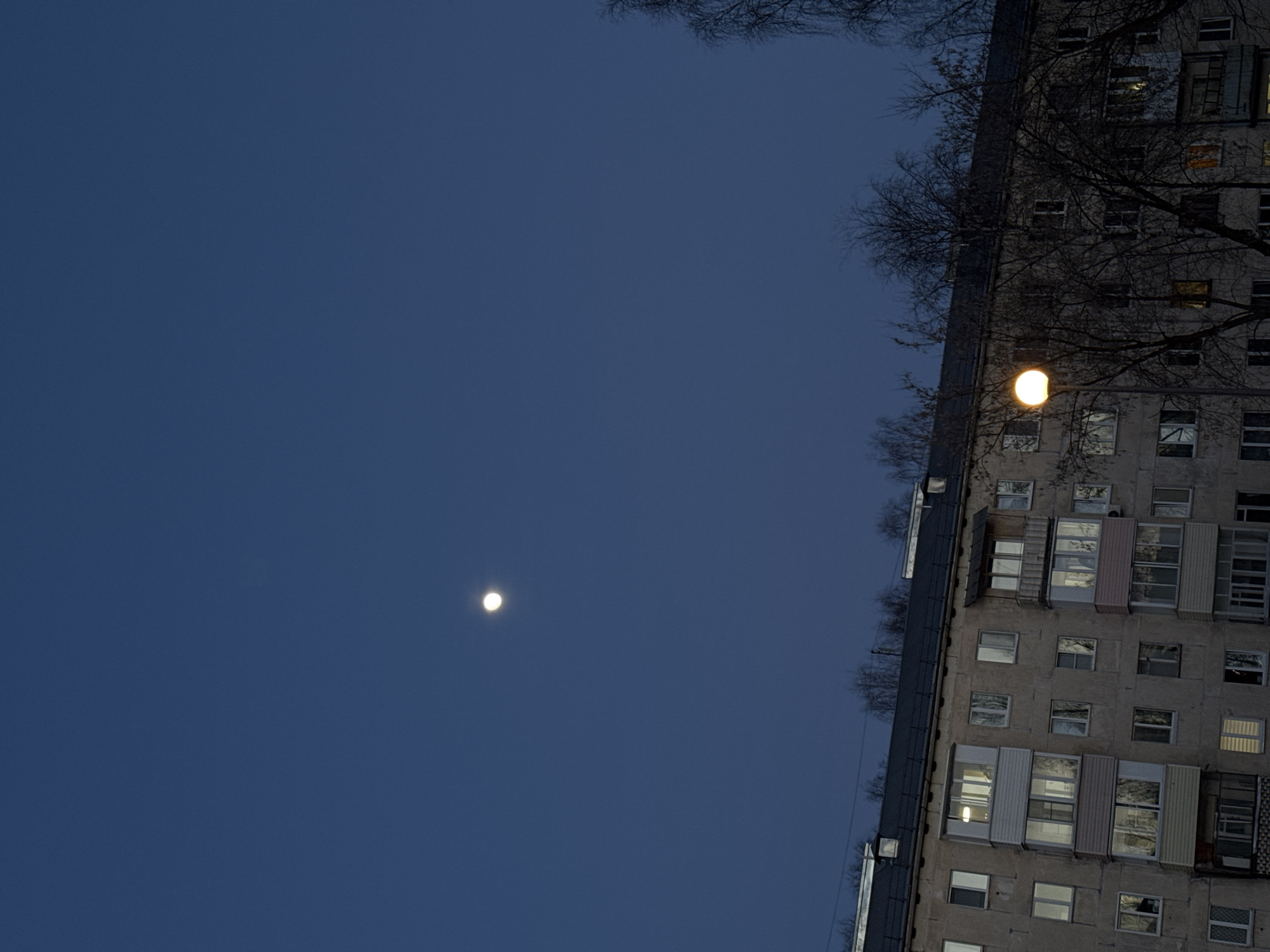 Nighttime apartment building illuminated by street lighting in Izhevsk