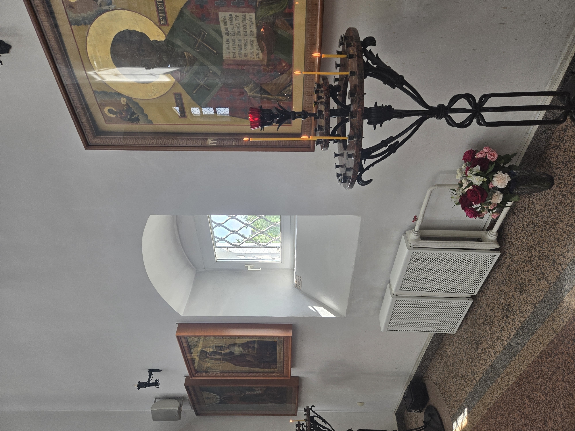 Church interior with icon and chandelier documented in Dolgoprudny