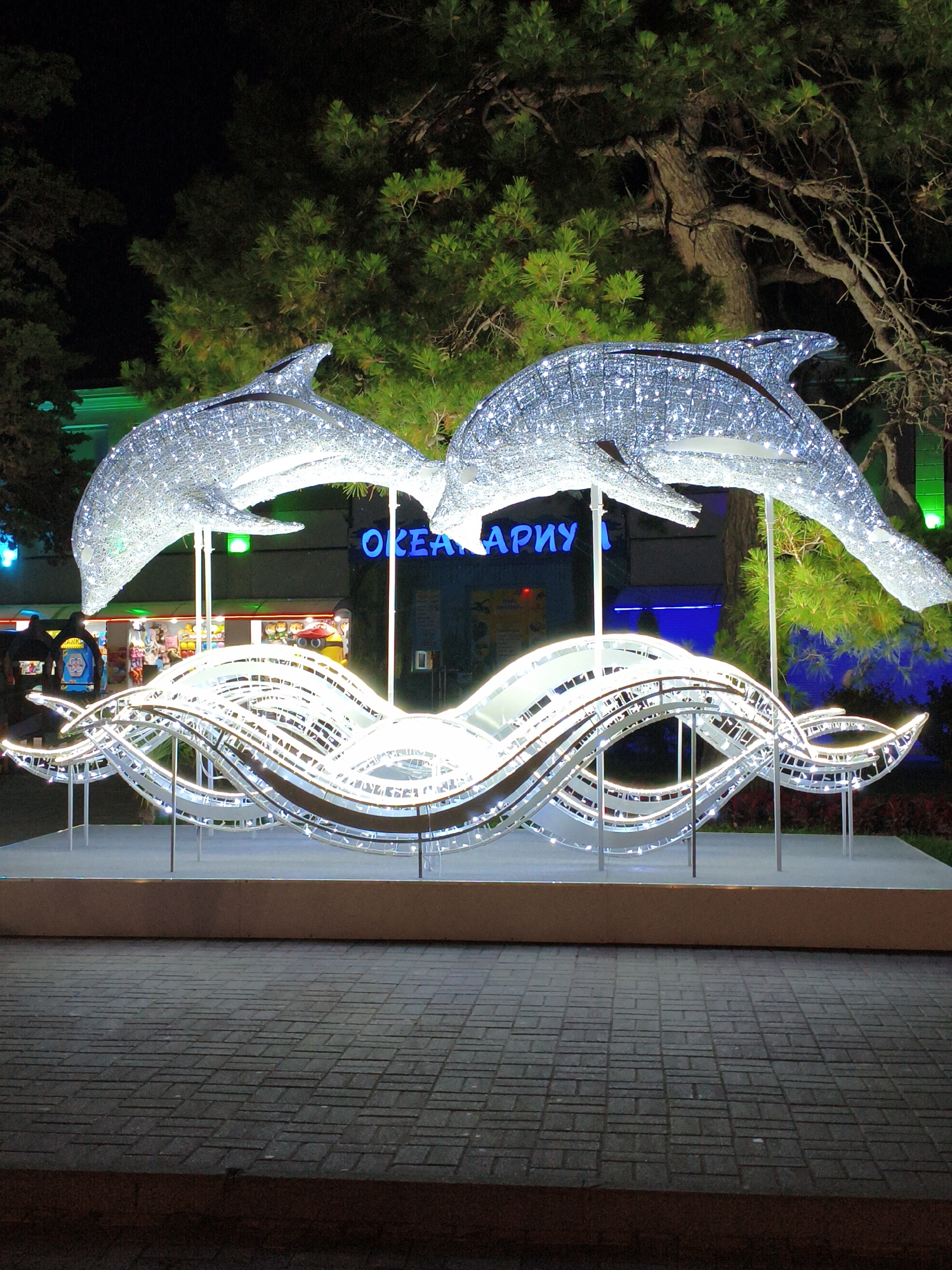 Decorated harbor promenade lit up on a summer night
