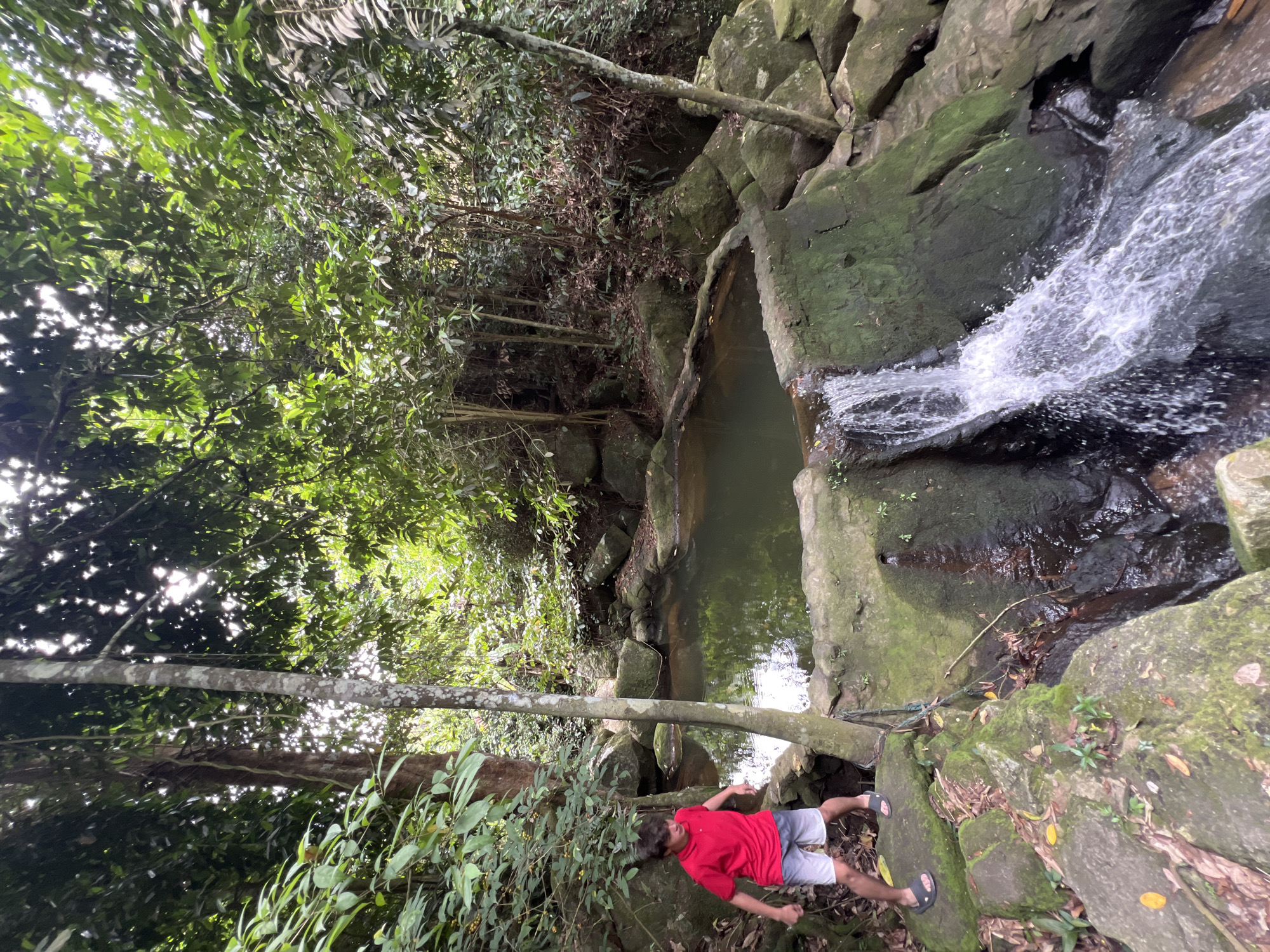 Safari tour group explores a jungle waterfall and ruins on Ko Samui