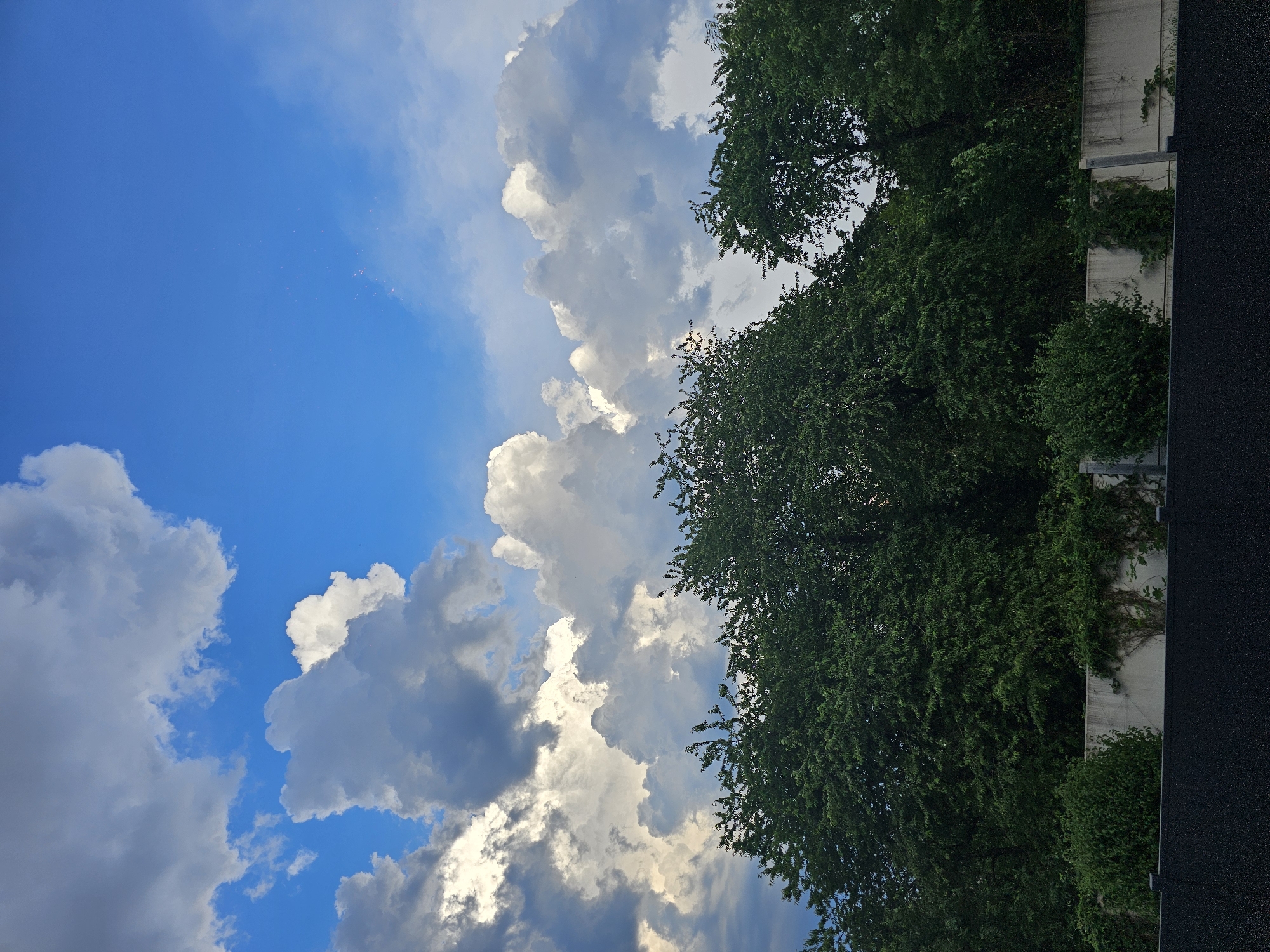 Residential streets and shifting skies on a cloudy afternoon