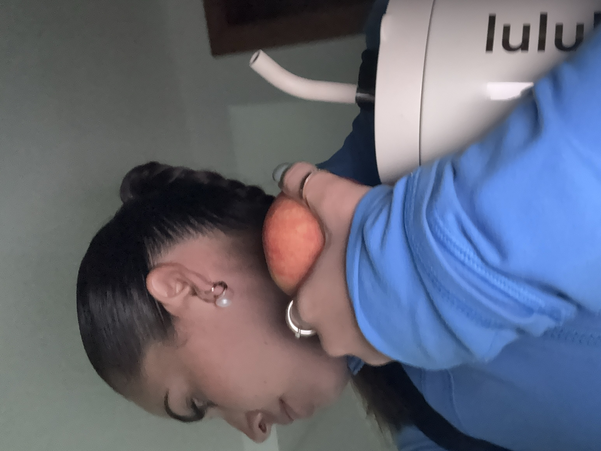 Woman with peach, water tumbler observed in Tlaxcalancingo
