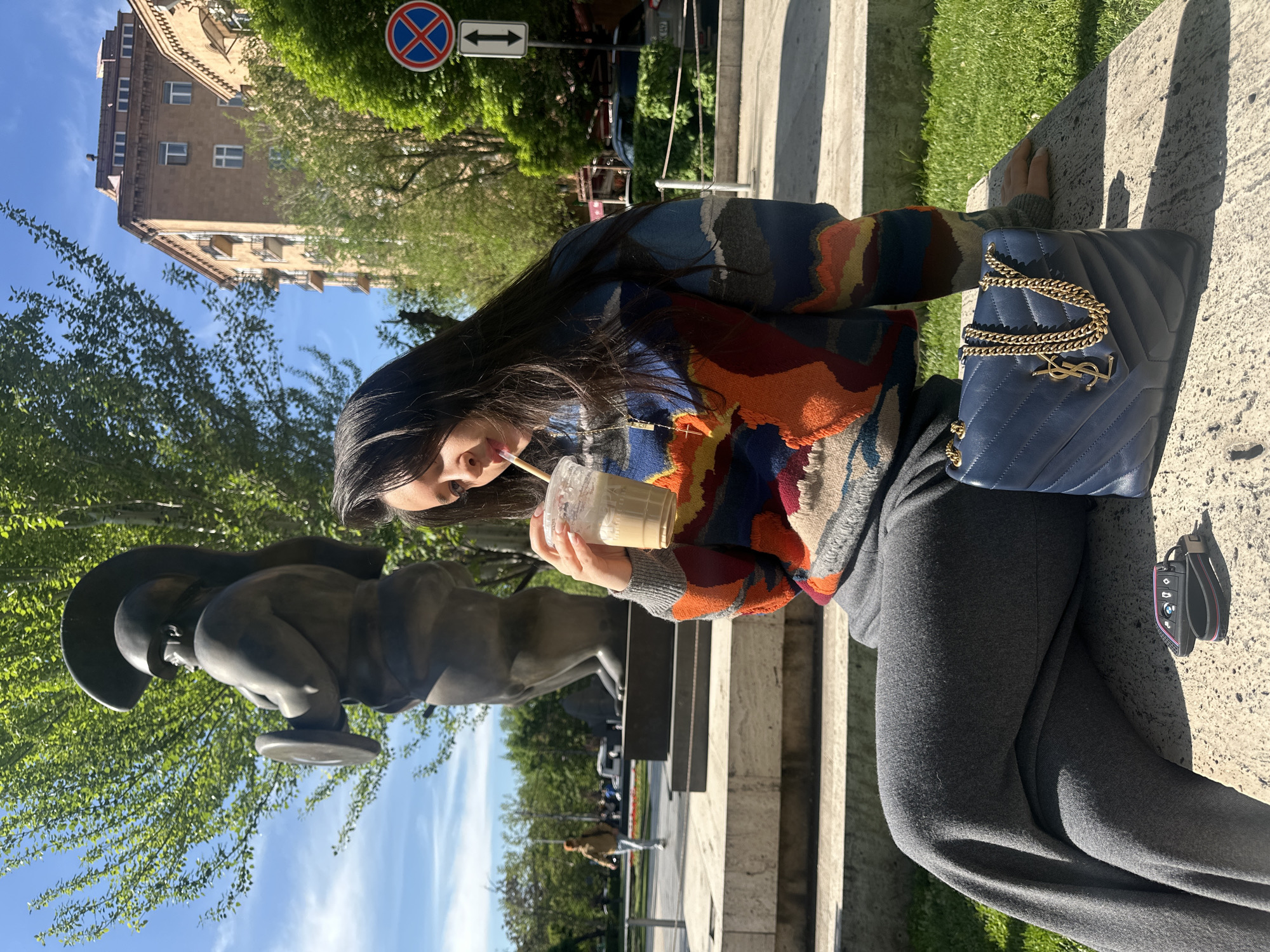 Woman enjoys morning drink with luxury accessories in Yerevan