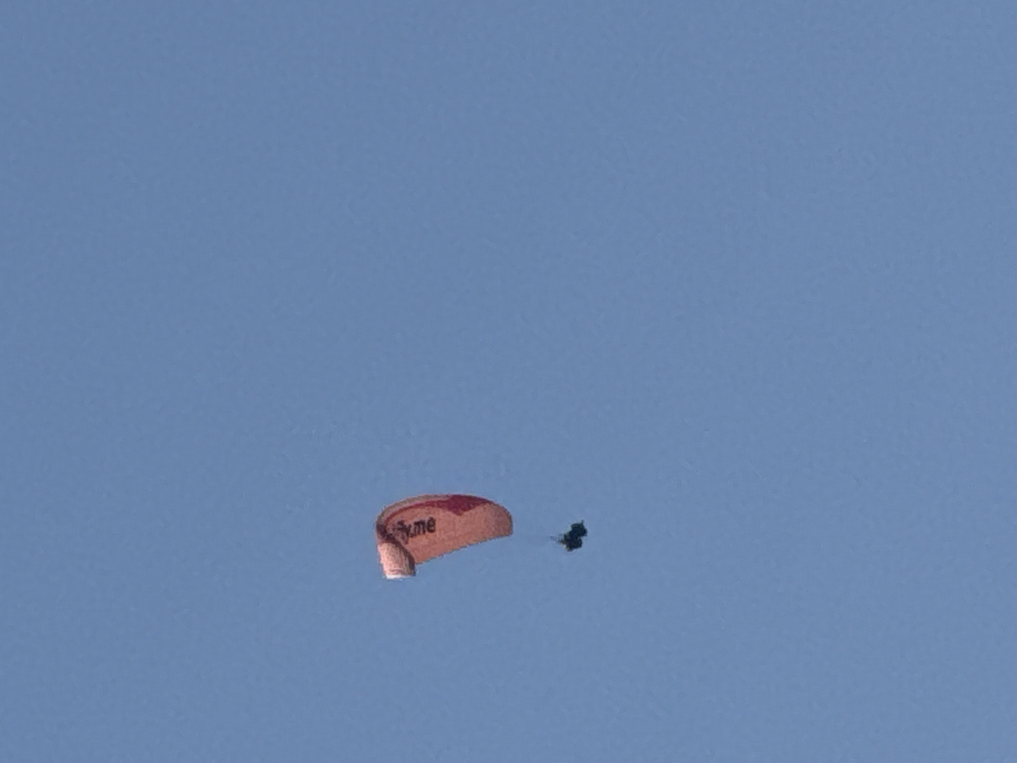 Paragliders over Boreti while keys and snacks feature indoors