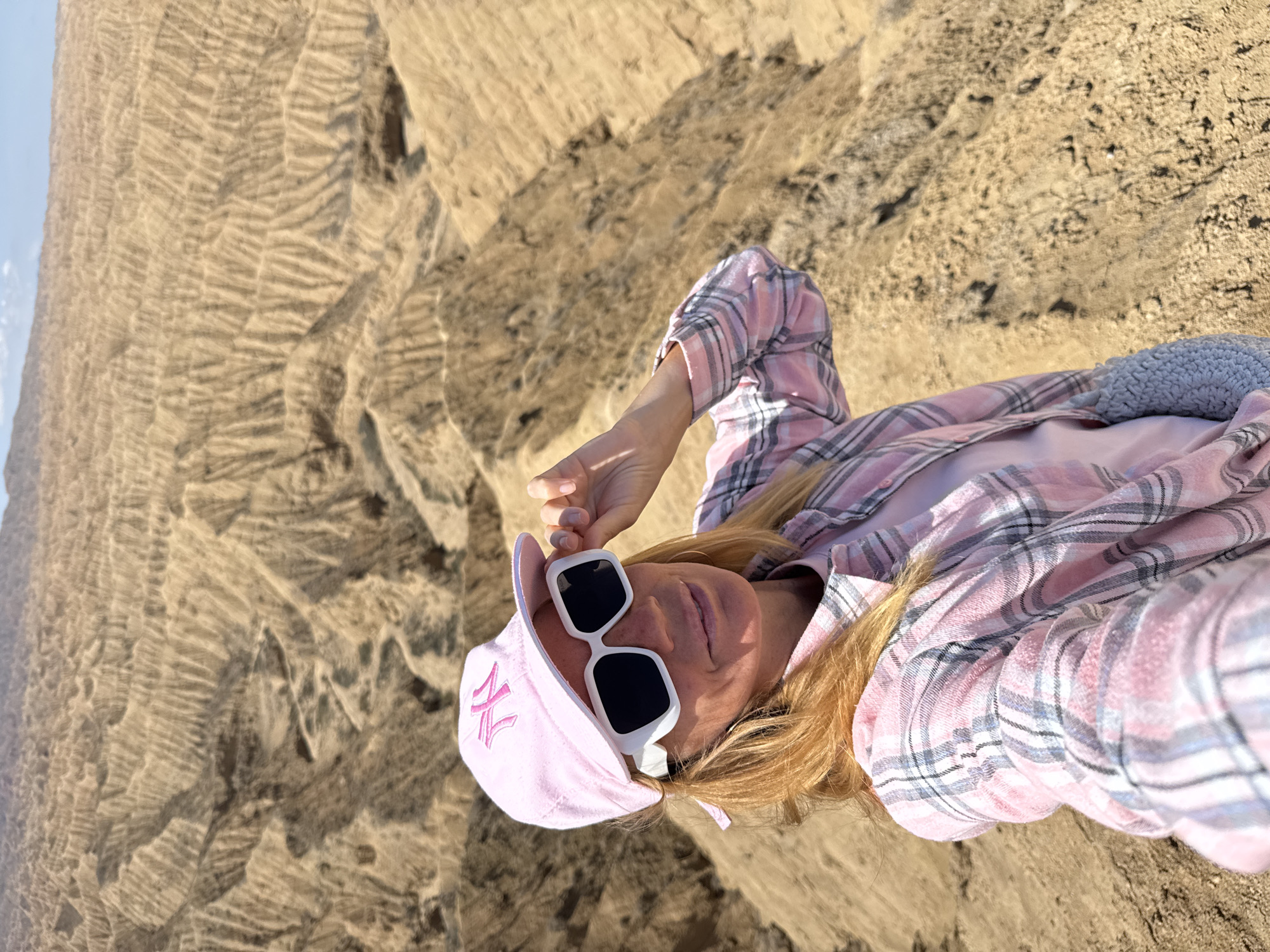 Tourists explore dramatic badlands formations near Tong, Kyrgyzstan