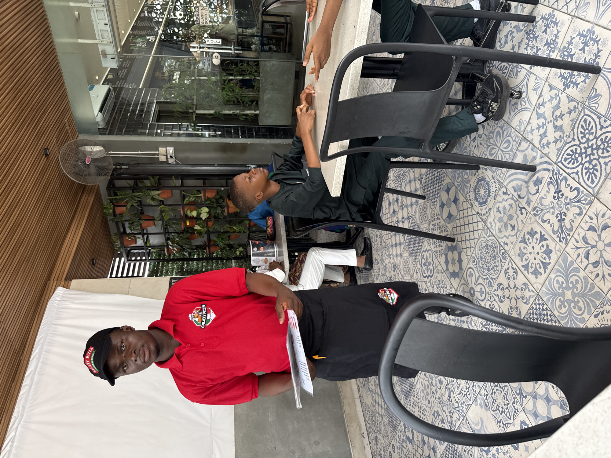 Diners gather at outdoor café in Abuja during morning hours