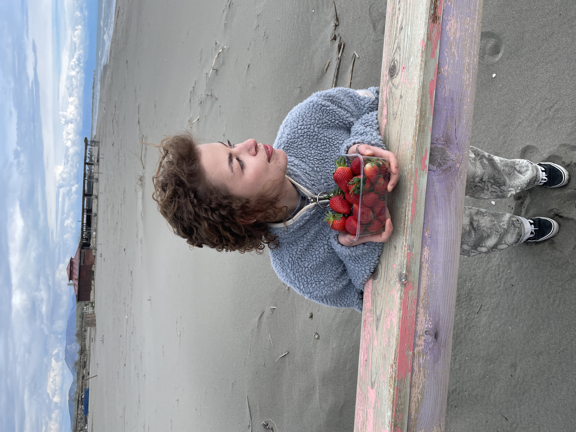 Woman enjoys beach day with strawberries in Montenegro