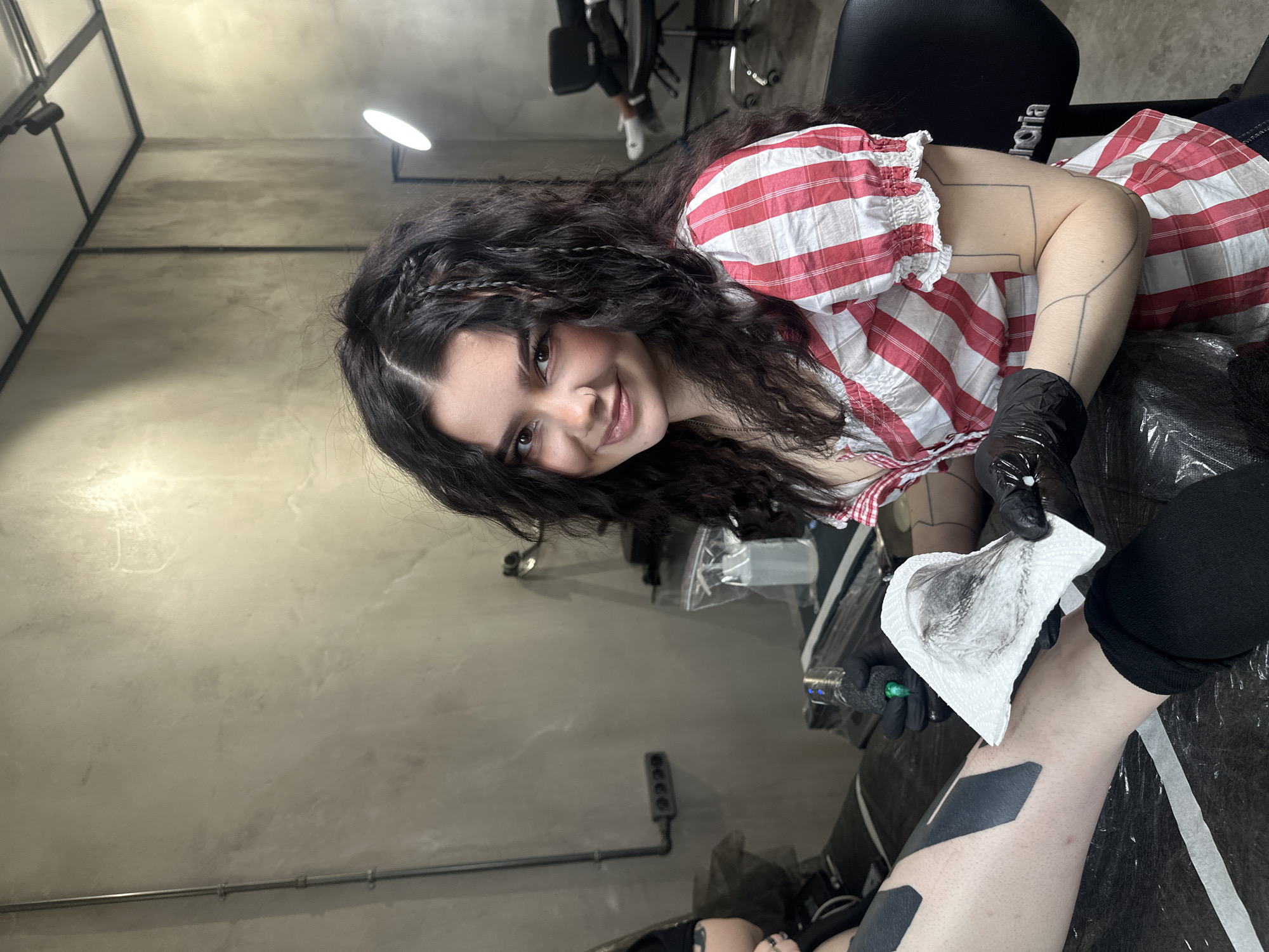Moscow tattoo artist photographed smiling at workplace