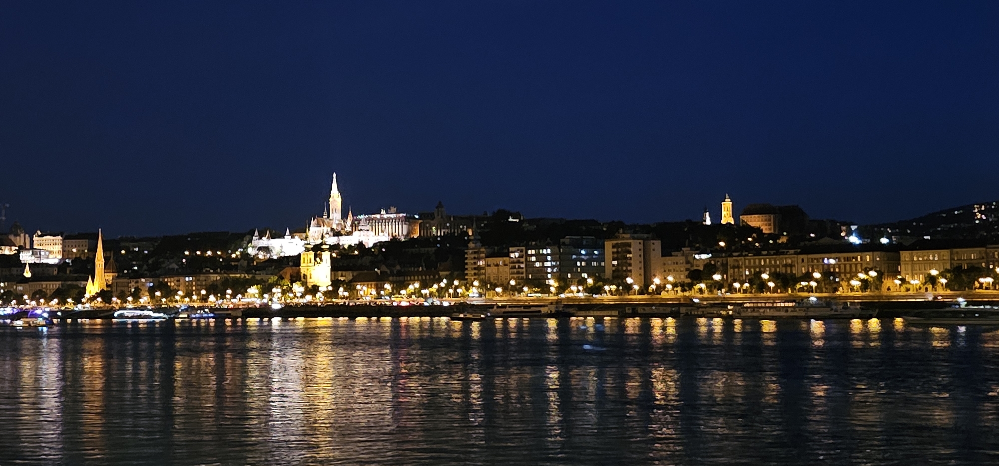 Budapest skyline glows across the Danube at night