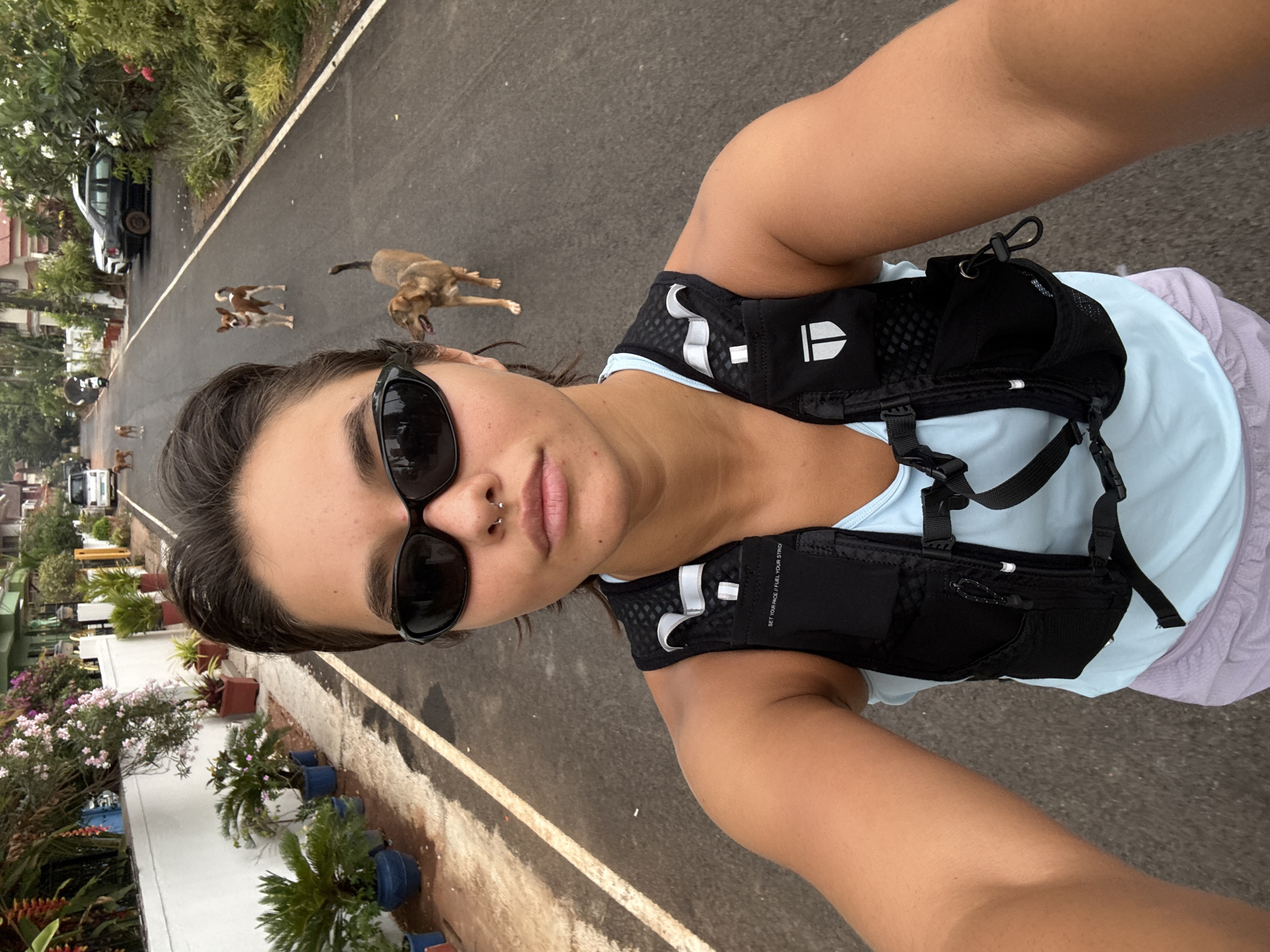 Runner takes selfie with approaching dogs on Indian road