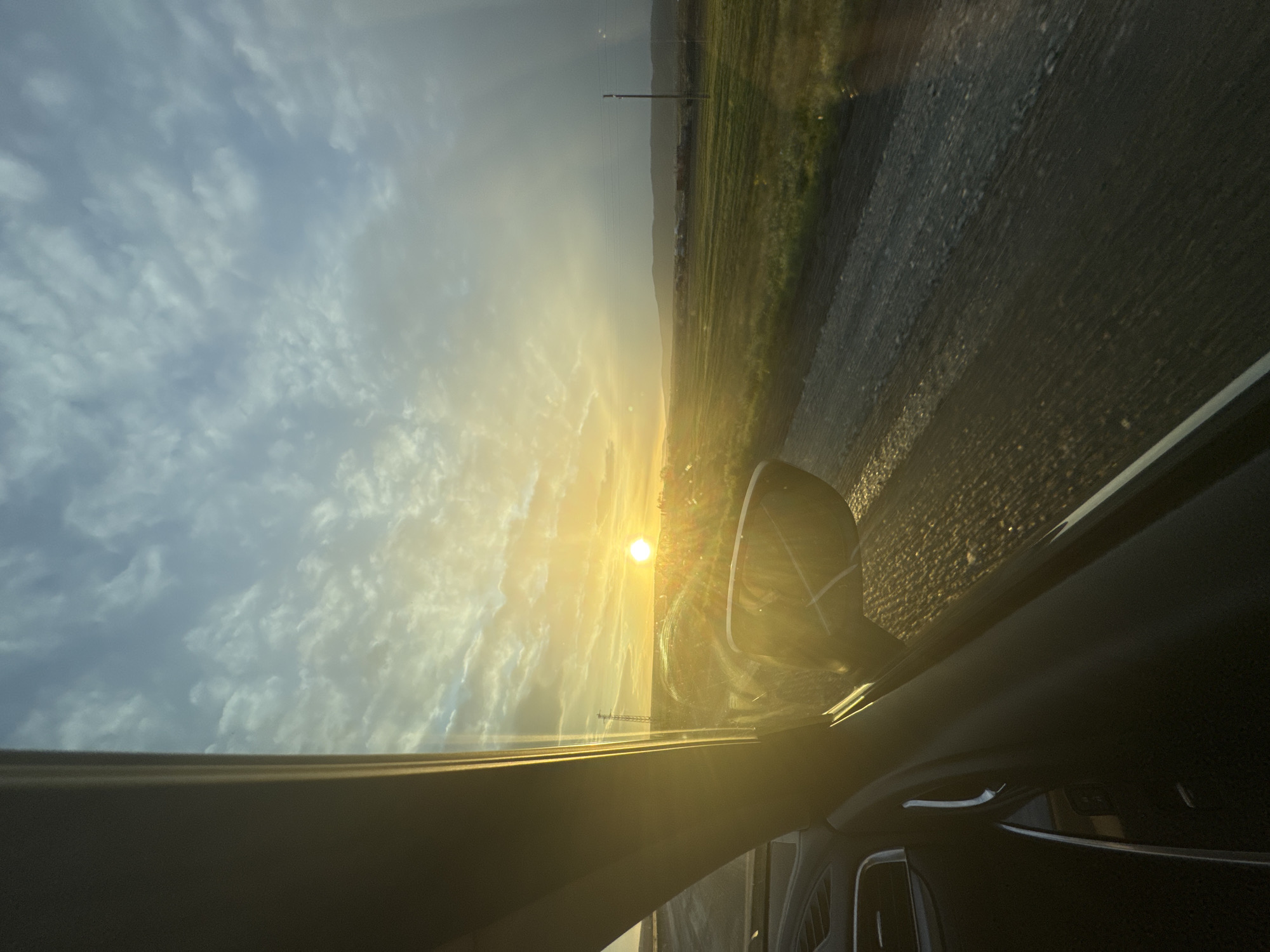 Driver captures sunset view through windshield in Aytos, Bulgaria