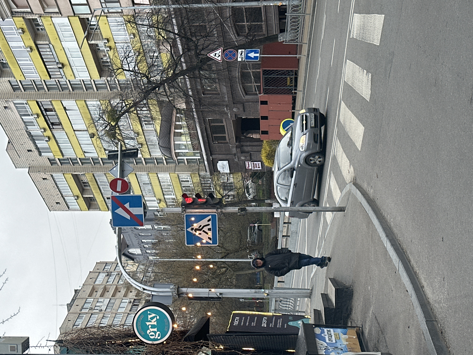 Morning street crossing captured in overcast Kyiv