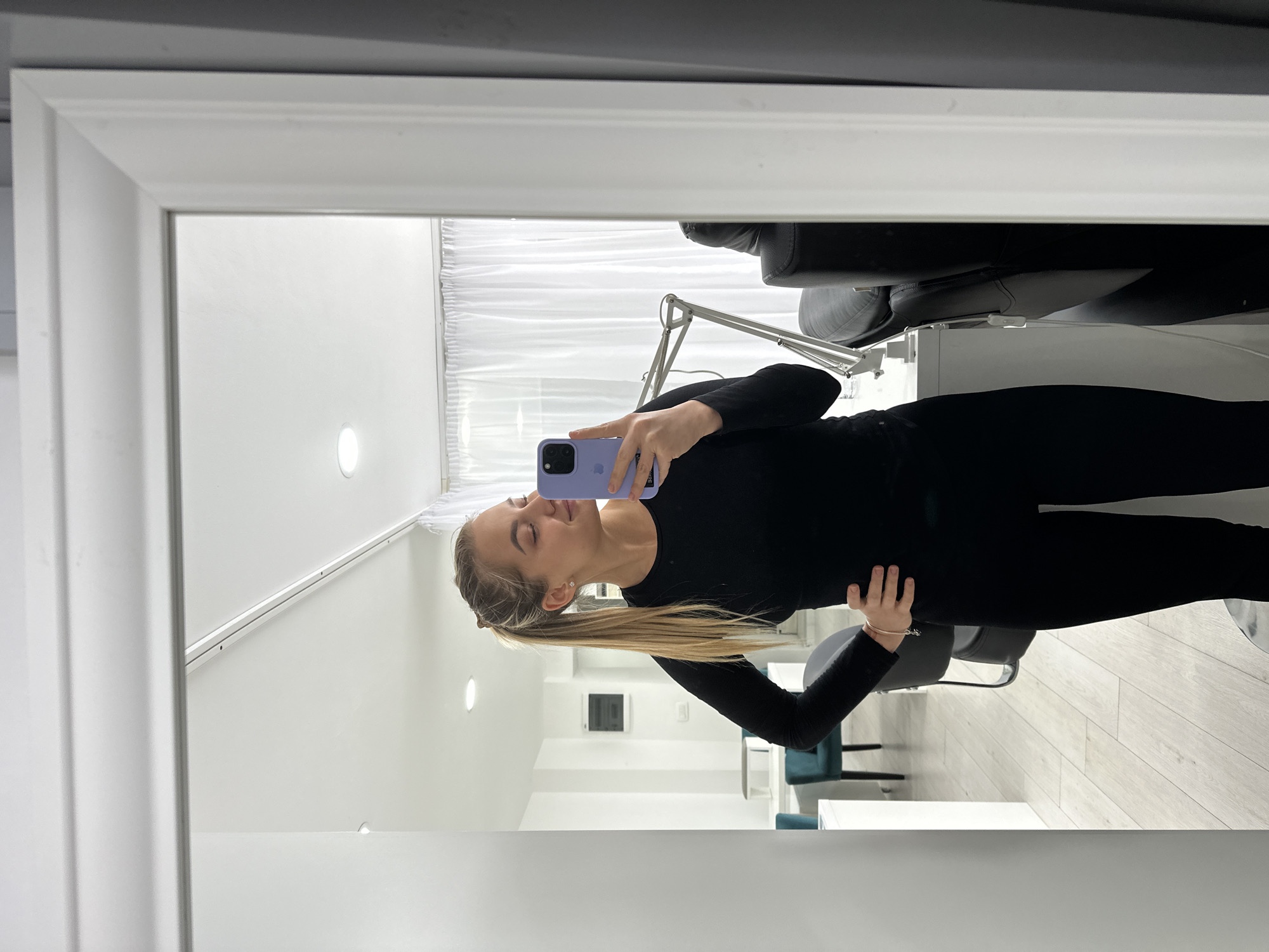 Woman takes selfies indoors in Budva, Montenegro