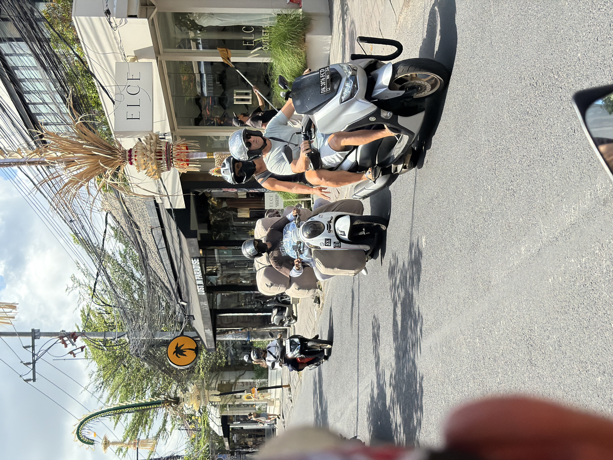 Busy street scene outside cafes and surf schools in North Kuta