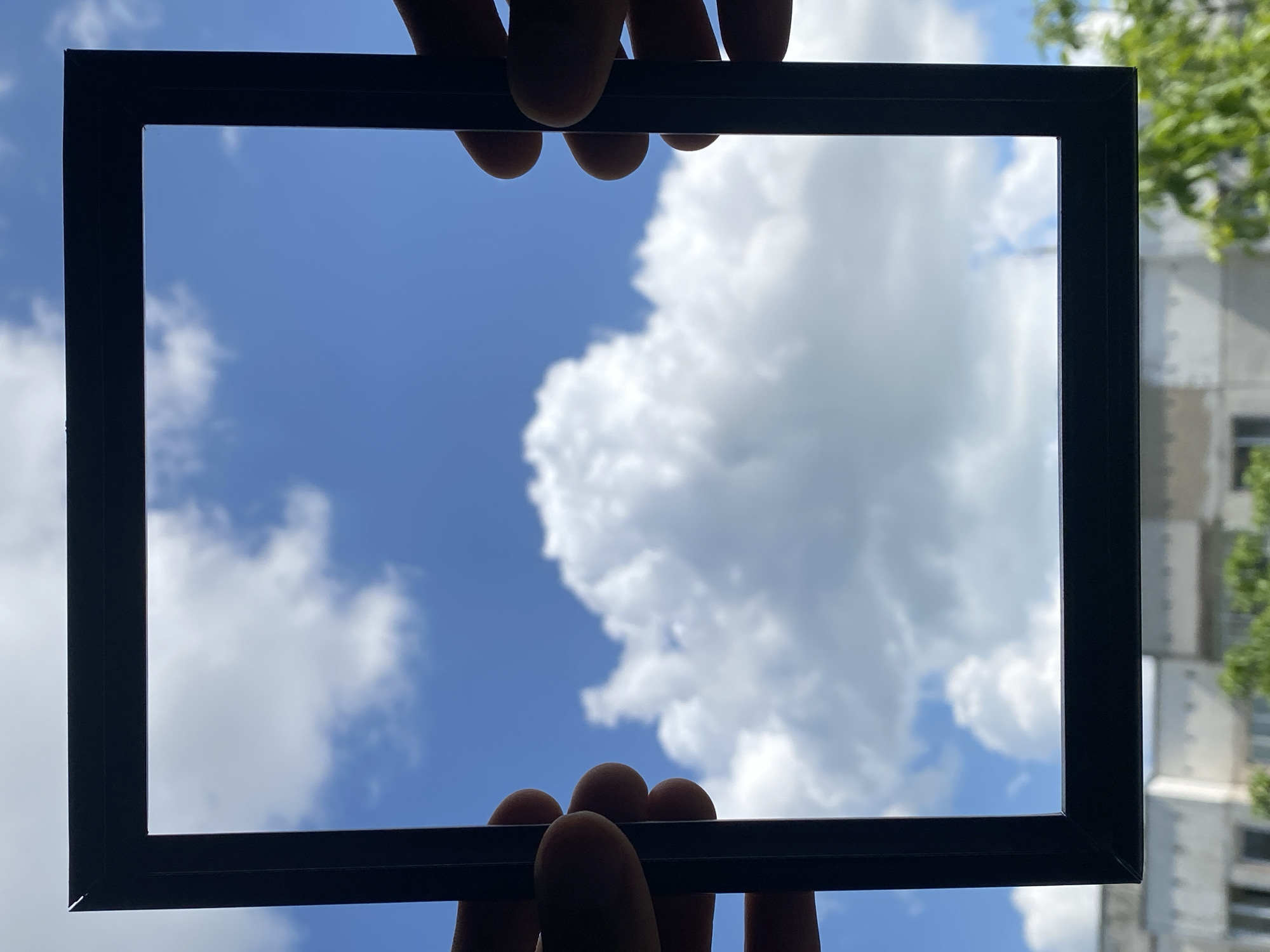 Person frames blue sky with clouds in Pleven