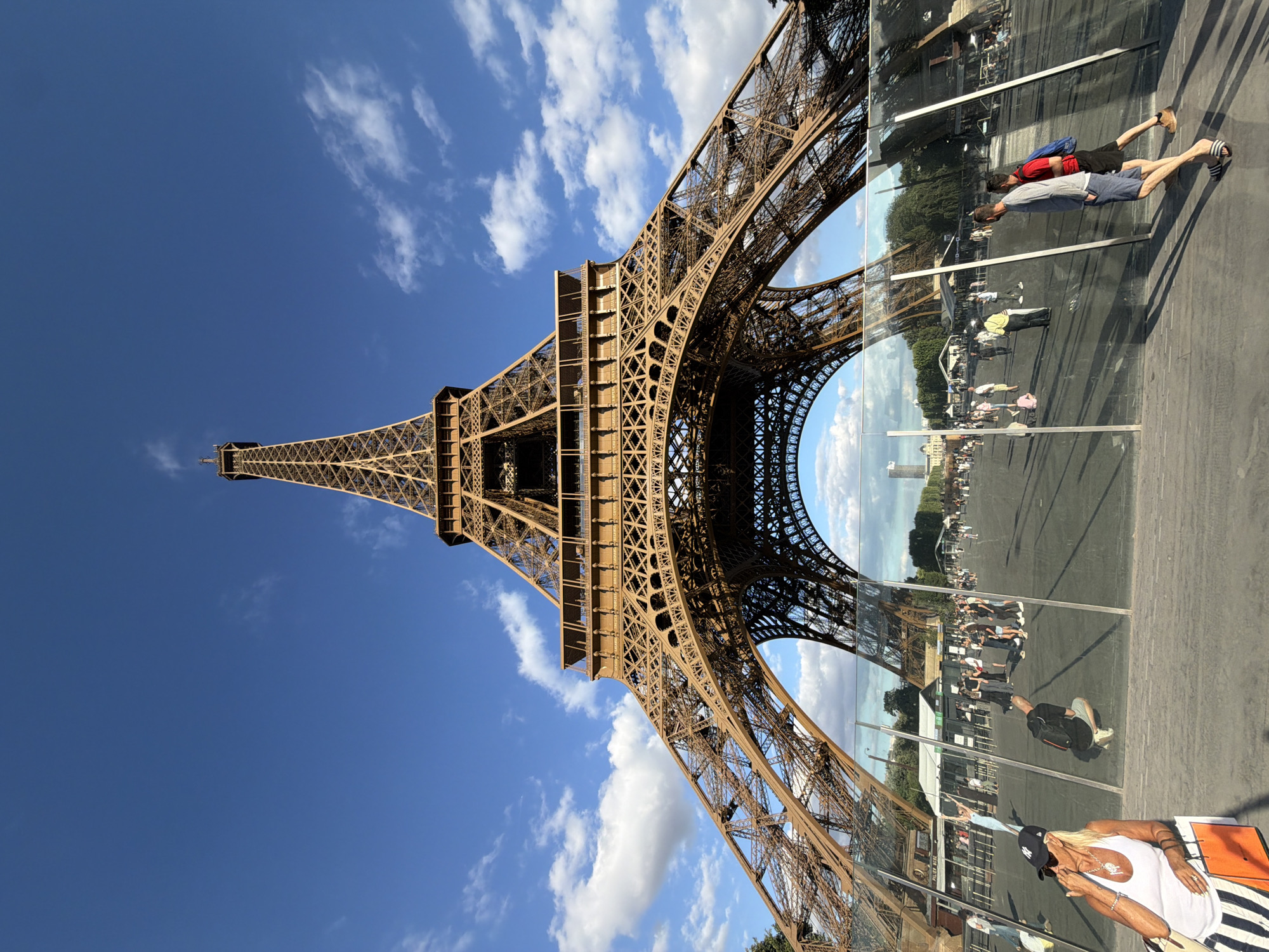 Looking straight up at the Eiffel Tower on a clear afternoon