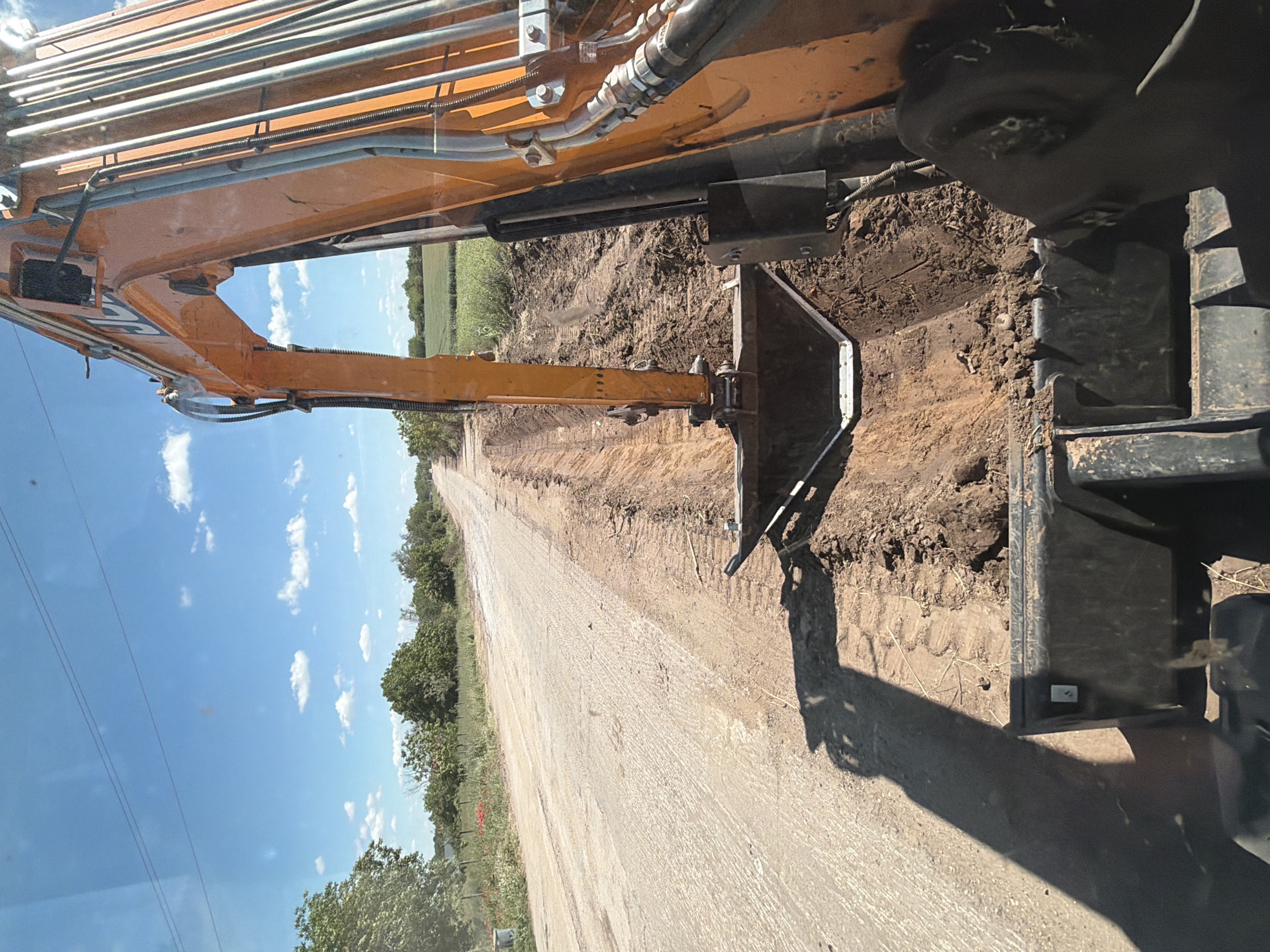 Excavator performs roadwork on dirt road in Oryahovo, Bulgaria