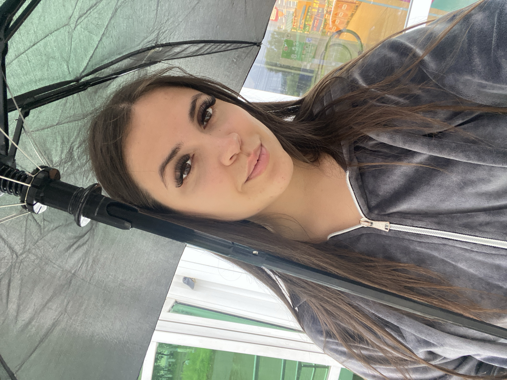 Rainy day scenes around Chaikovsky with umbrellas and wet streets