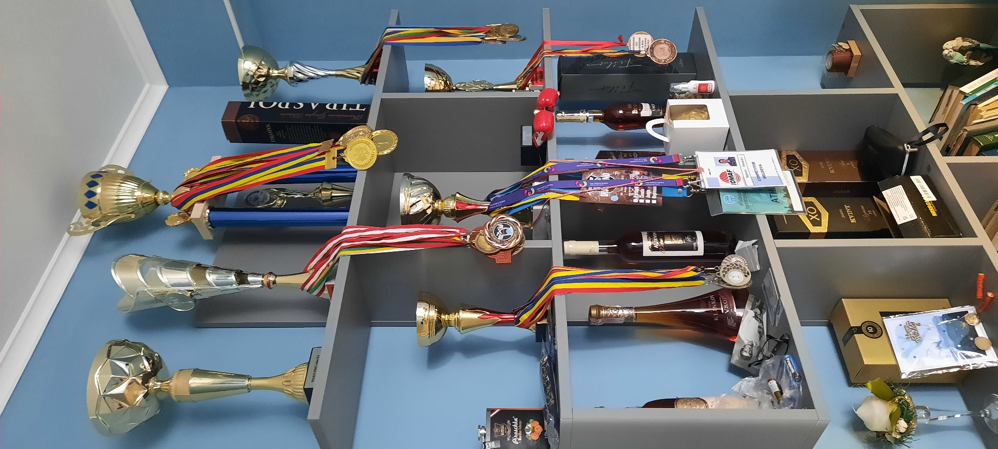 Trophies, clocks, and sneakers in a Chișinău room