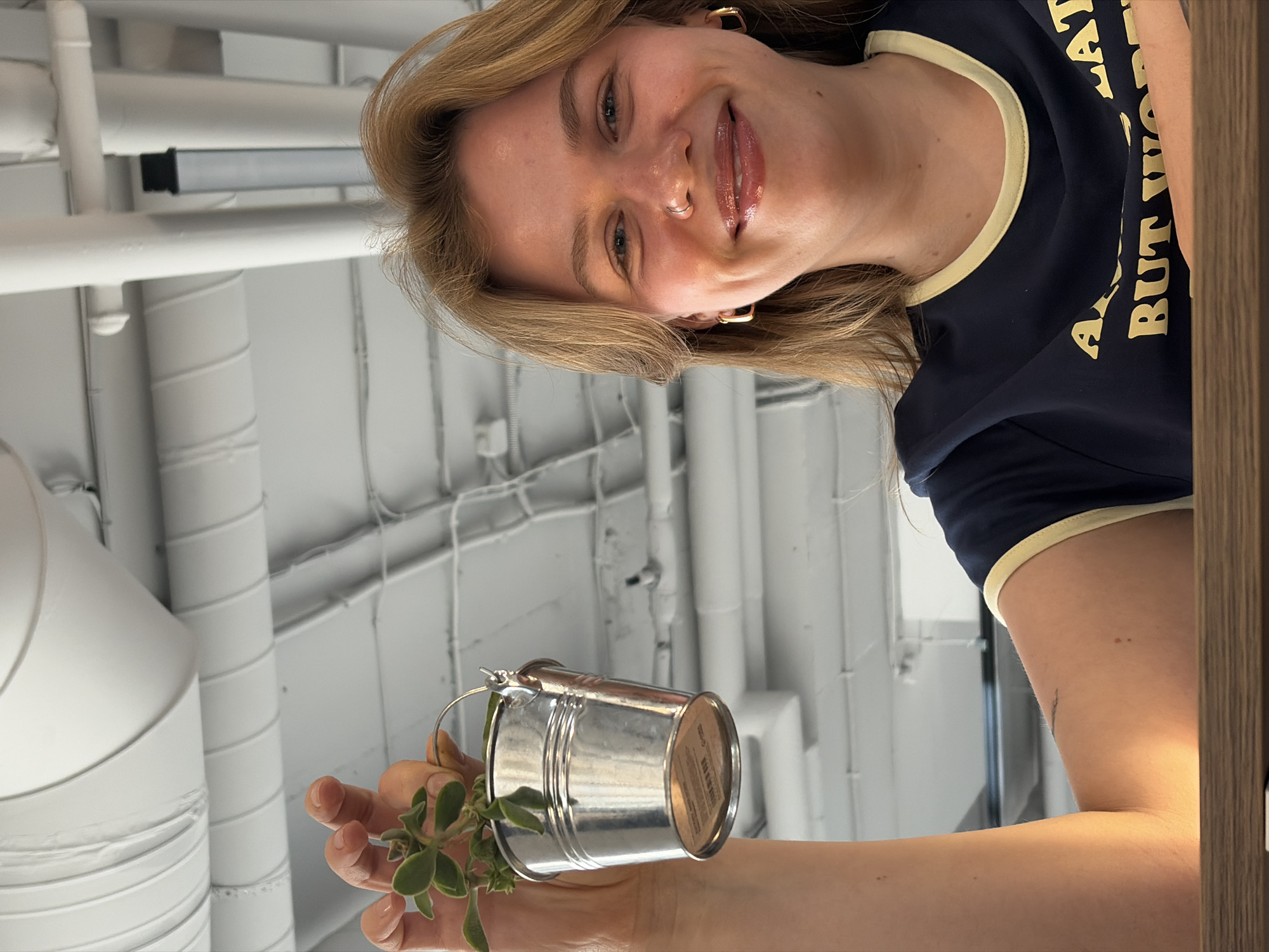 Woman poses with potted plant in rural Belarus