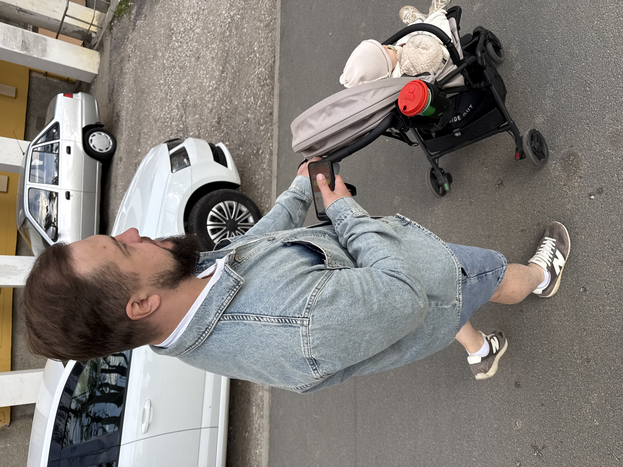 Family strolls through Vladimir streets with baby in afternoon