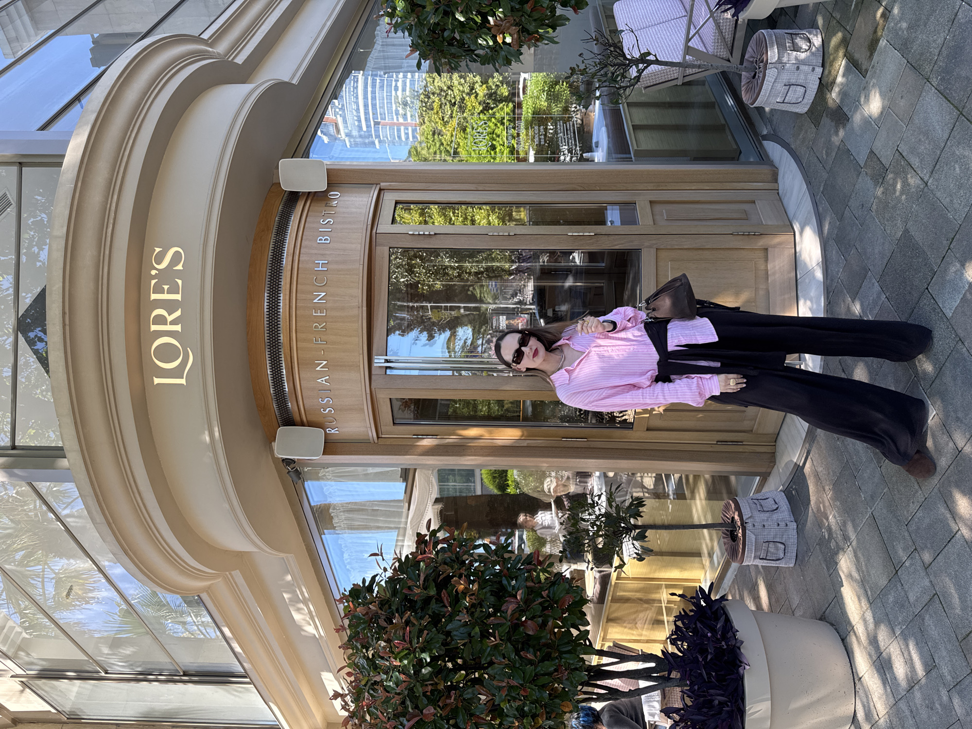 Woman documents dining experience at Sochi bistro and parks