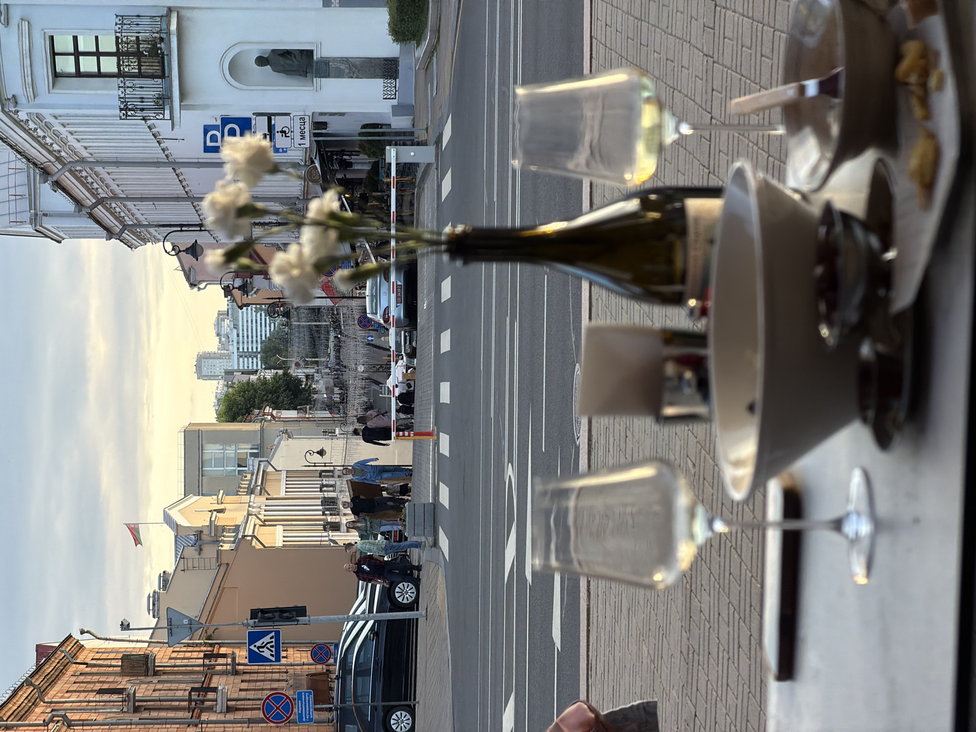 Afternoon drinks at a Minsk café terrace, street life below
