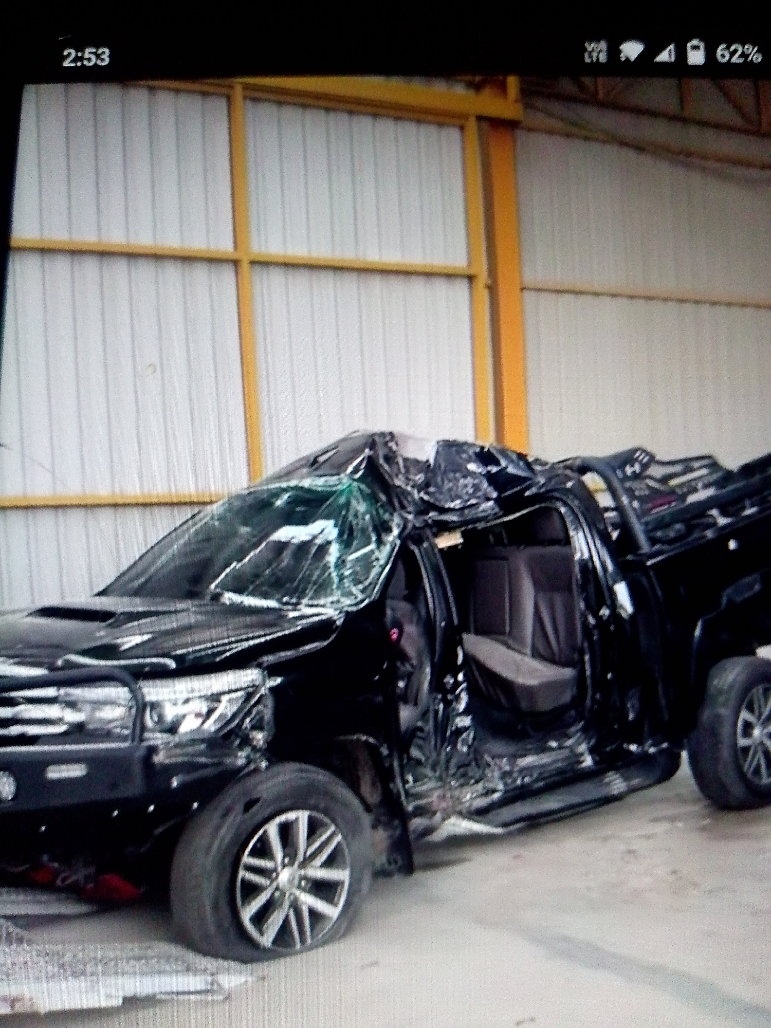 Two damaged vehicles observed in urban area collision aftermath