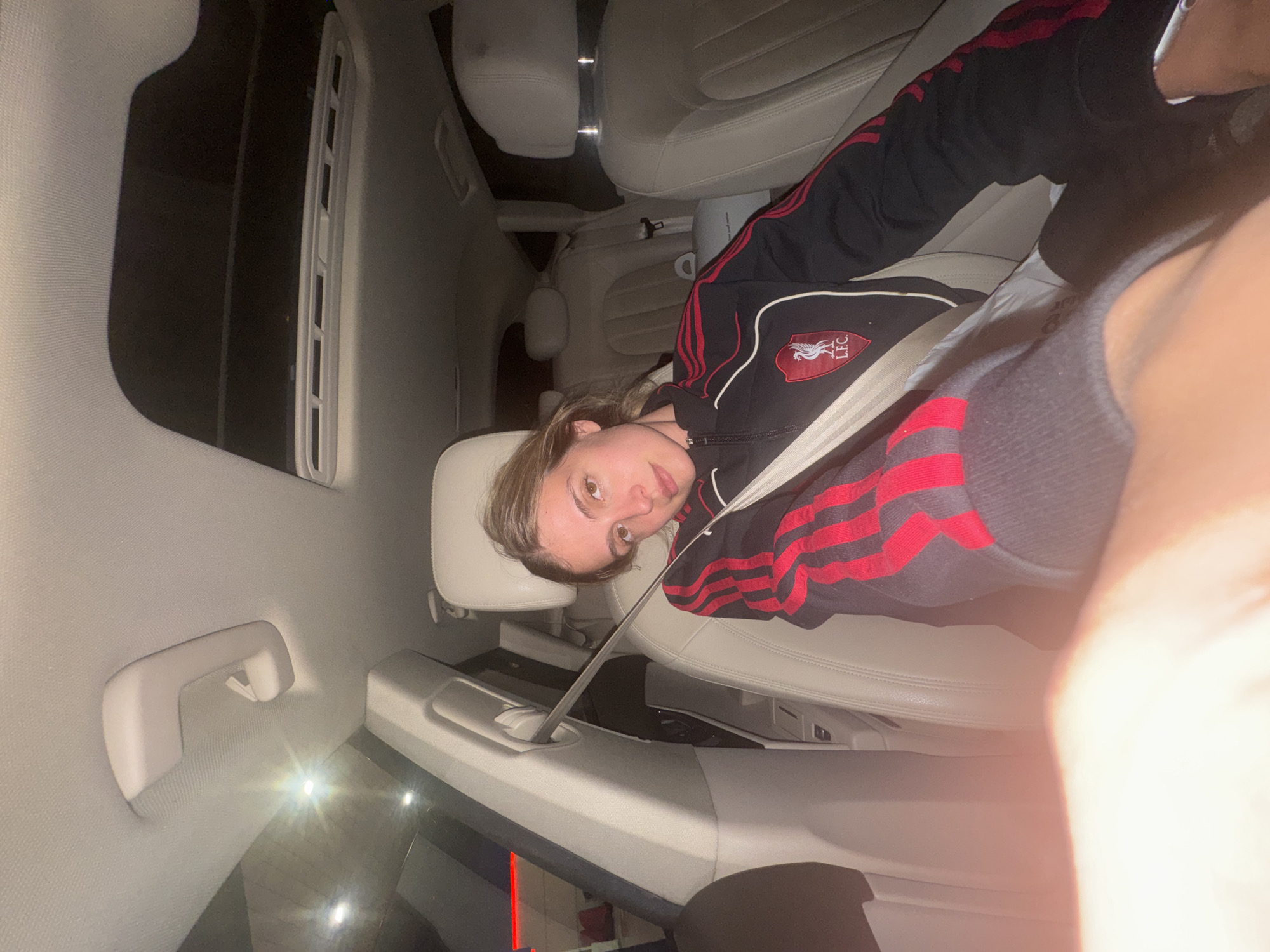 Young person rests in car backseat in Tbilisi