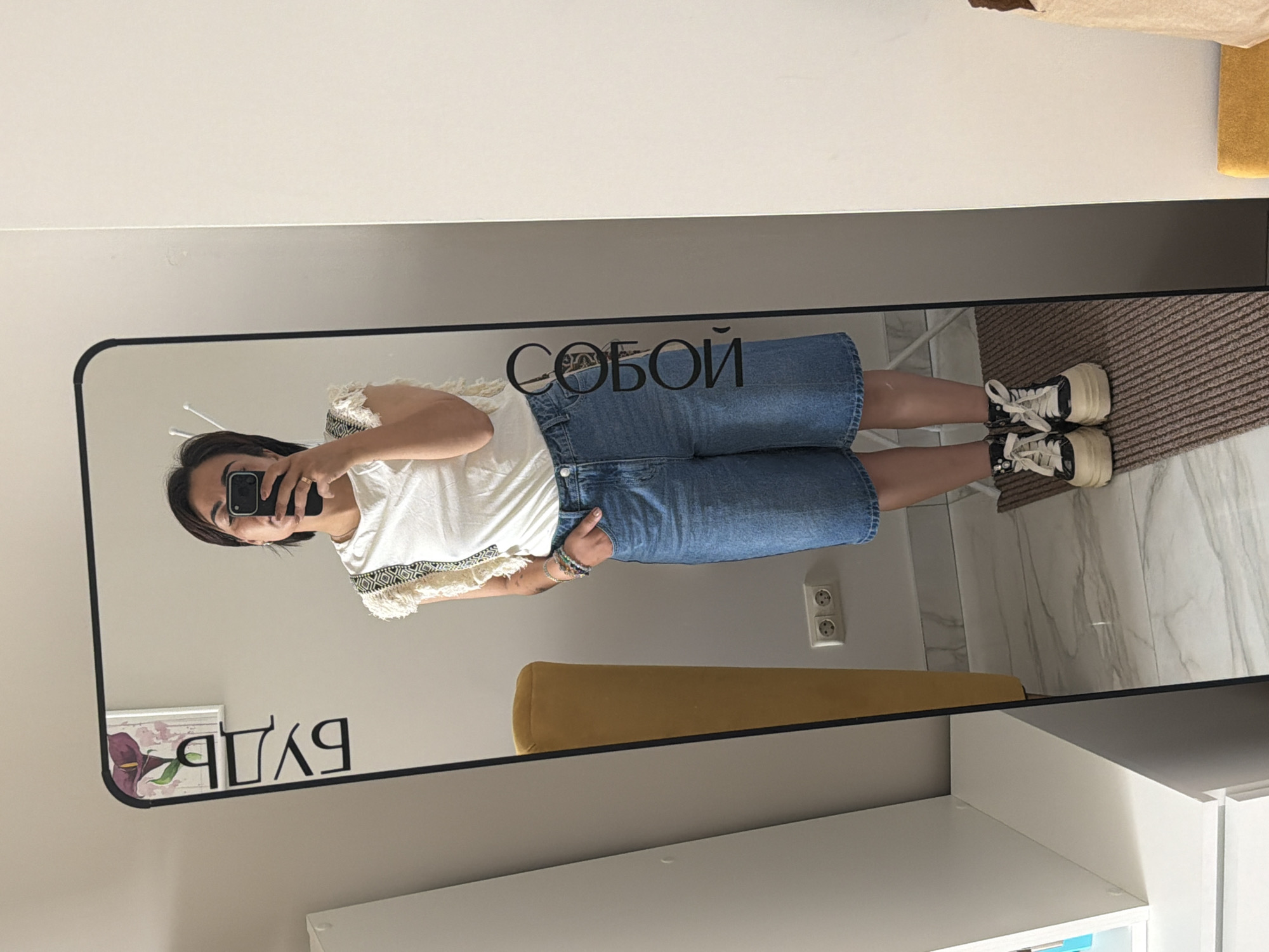 Mirror selfies in a Kamchatka home, same look twice