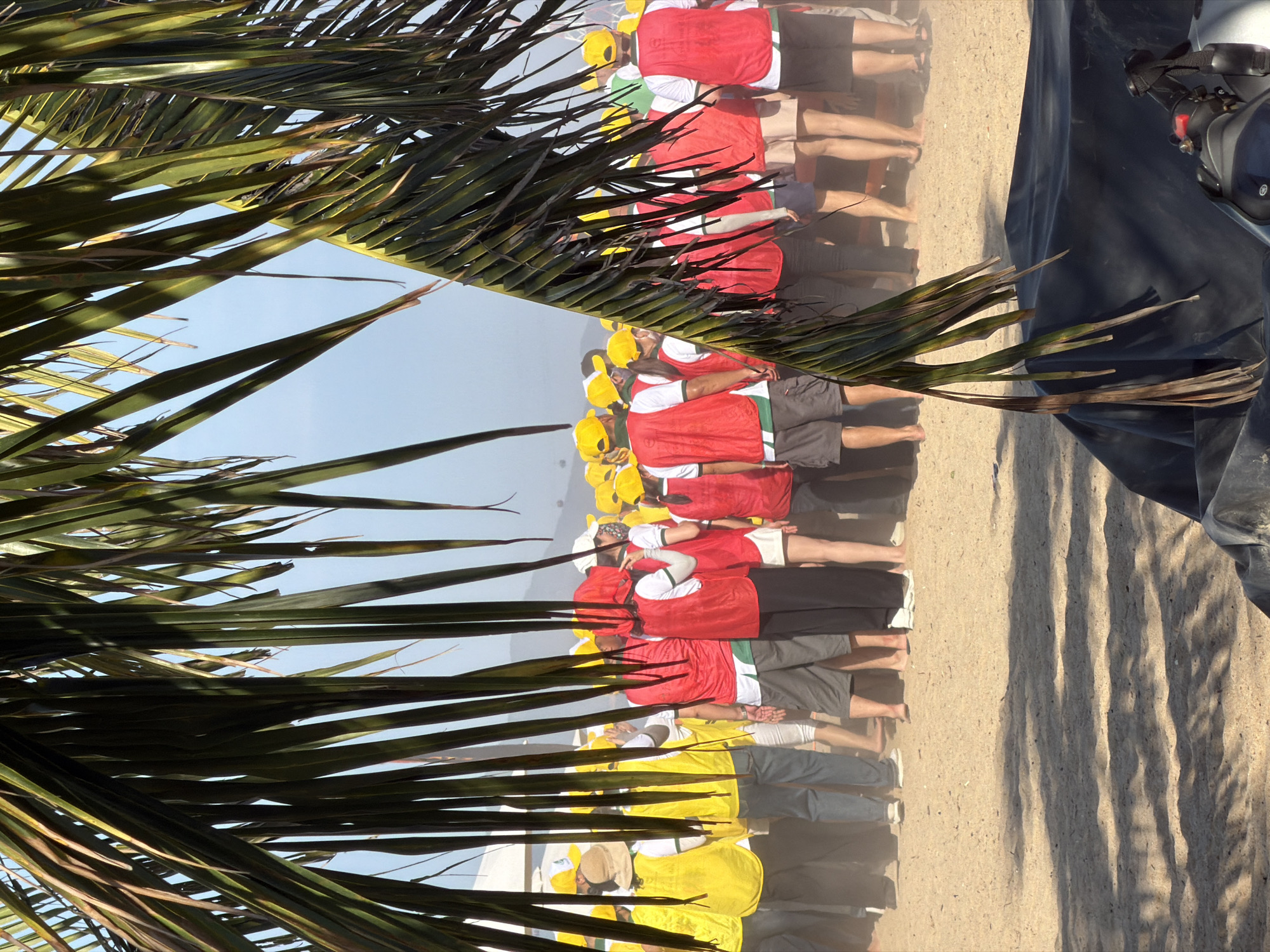 Team-building beach activity with yellow-hatted participants in Nha Trang