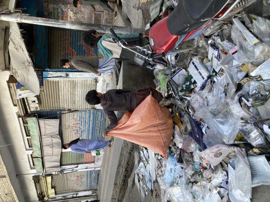 Forklift positioned near waste pile on Quetta street