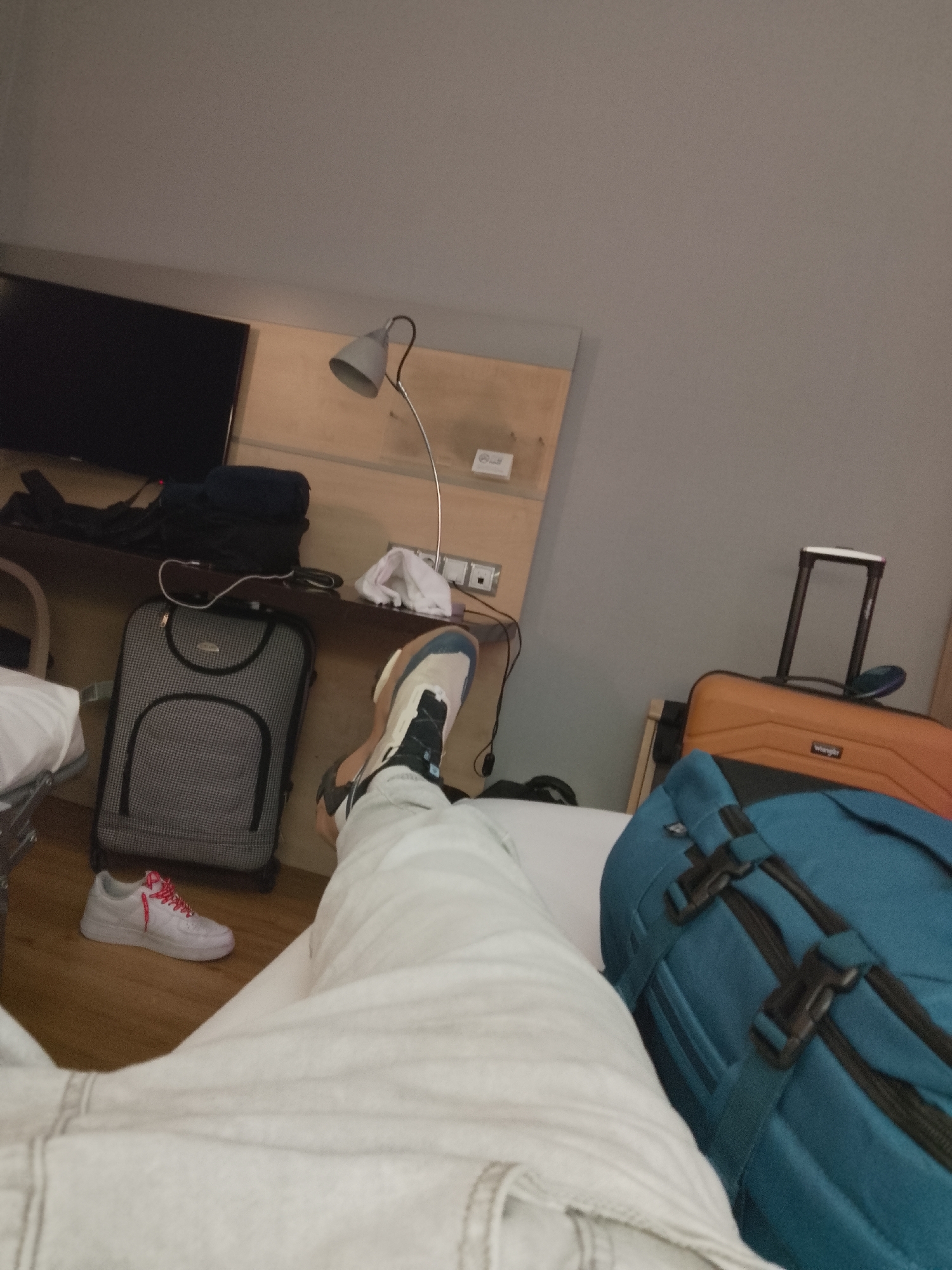 Person rests on hotel bed in Alcorcón