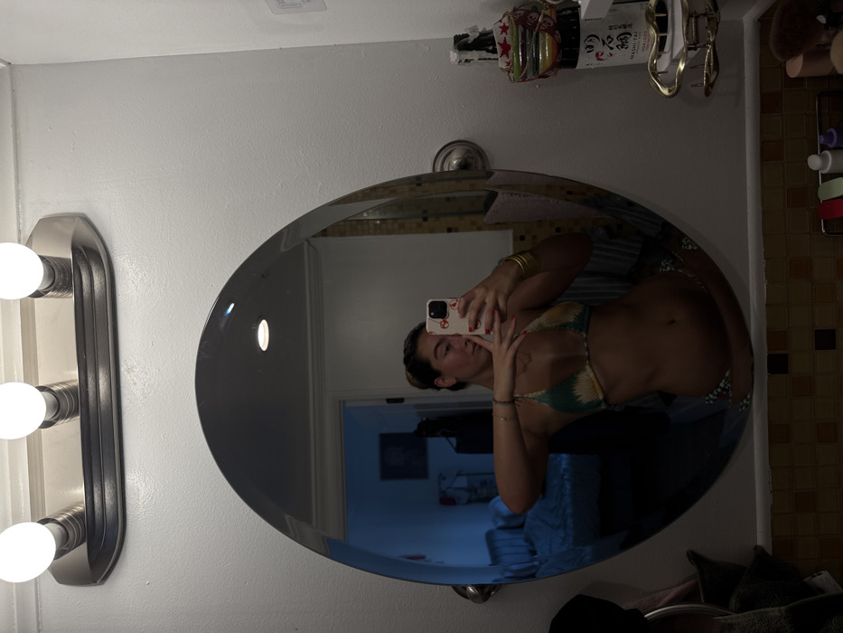 Woman uses bathroom mirror in Los Angeles residence
