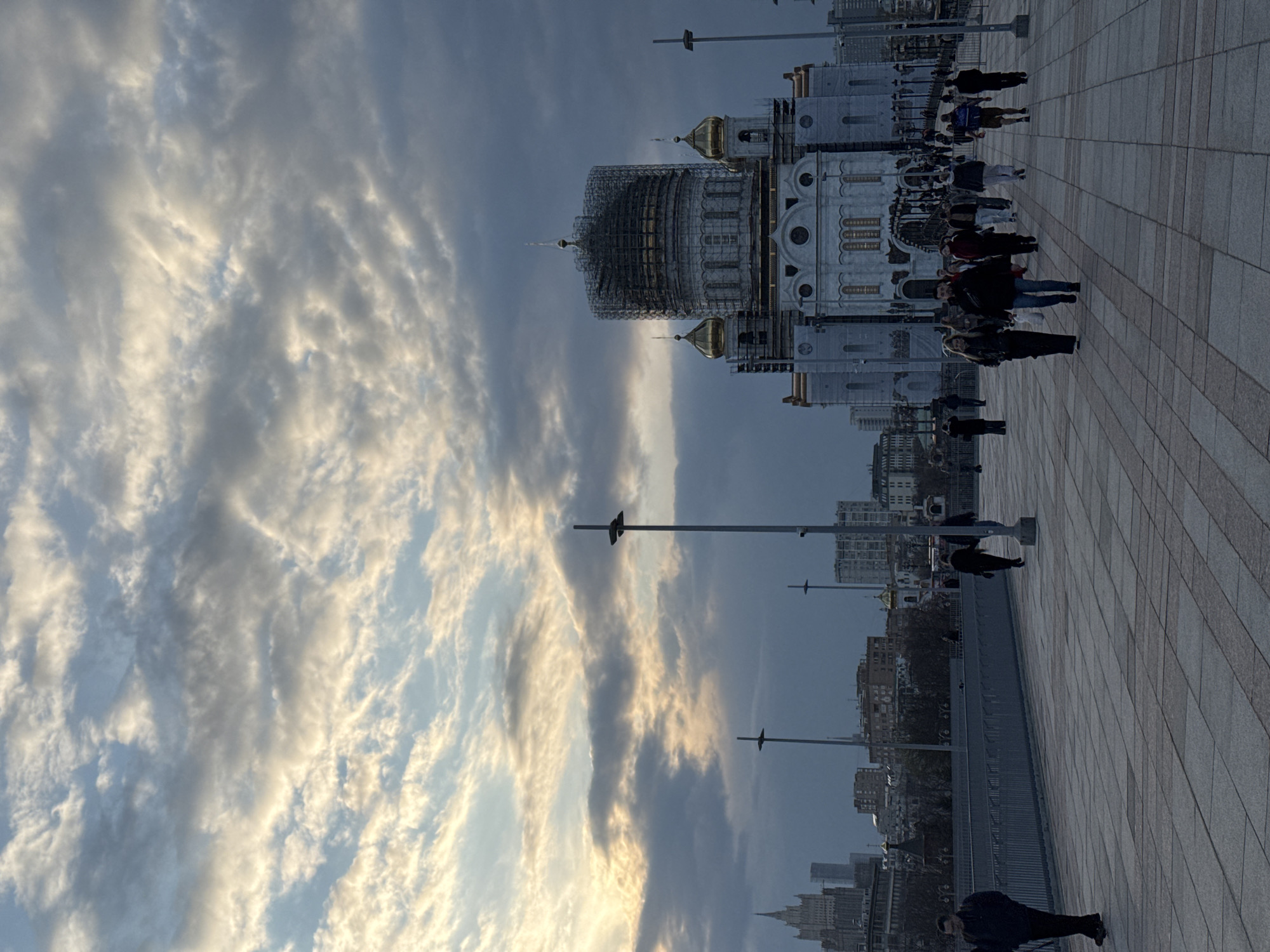 Moscow cathedral dome under construction as pedestrians gather nearby