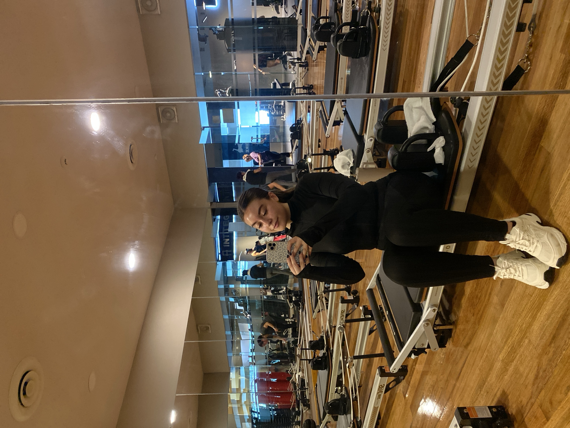 Woman exercises at Pilates studio during afternoon session