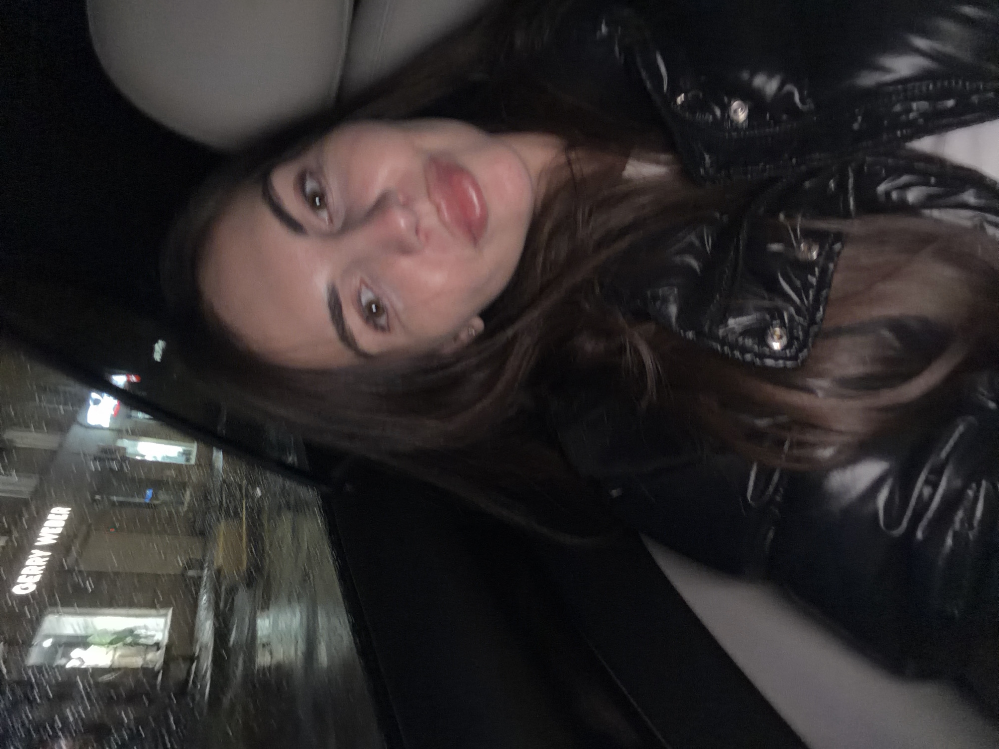 Two women travel by car through rainy Krasnoyarsk afternoon