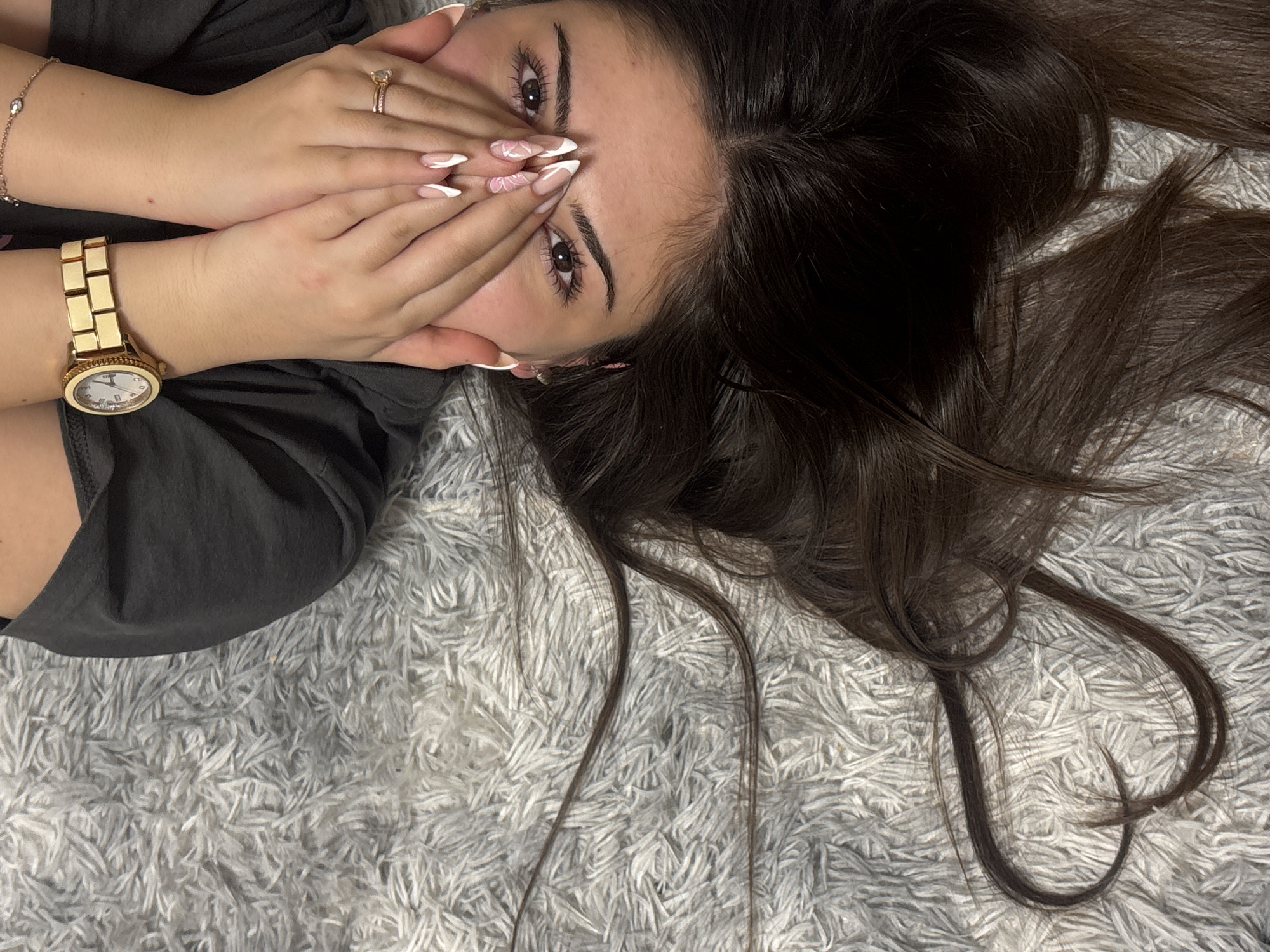 Woman lies on rug with hands over face in Lehchevo