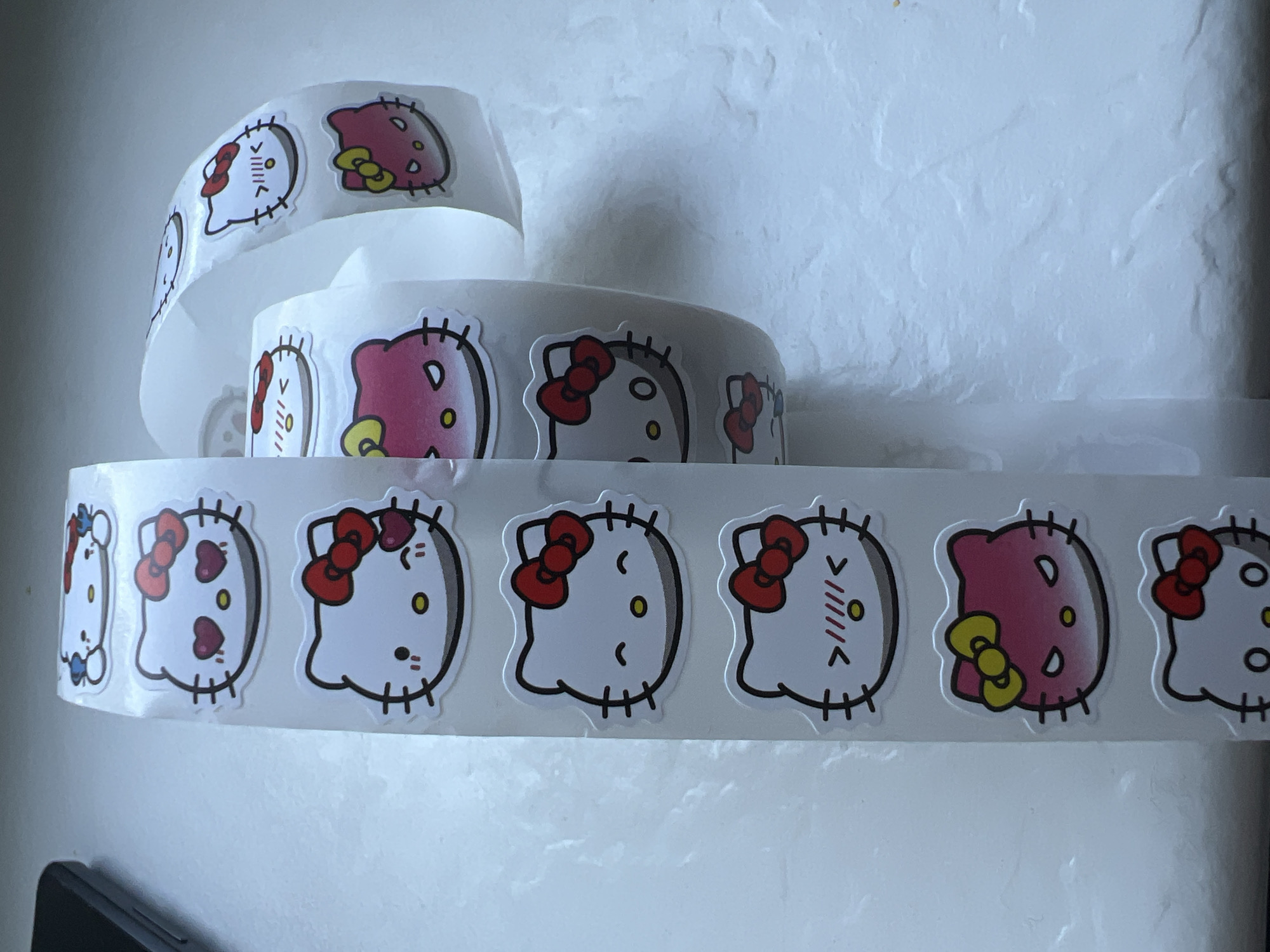 Hello Kitty sticker collection spread out and photographed in Warsaw