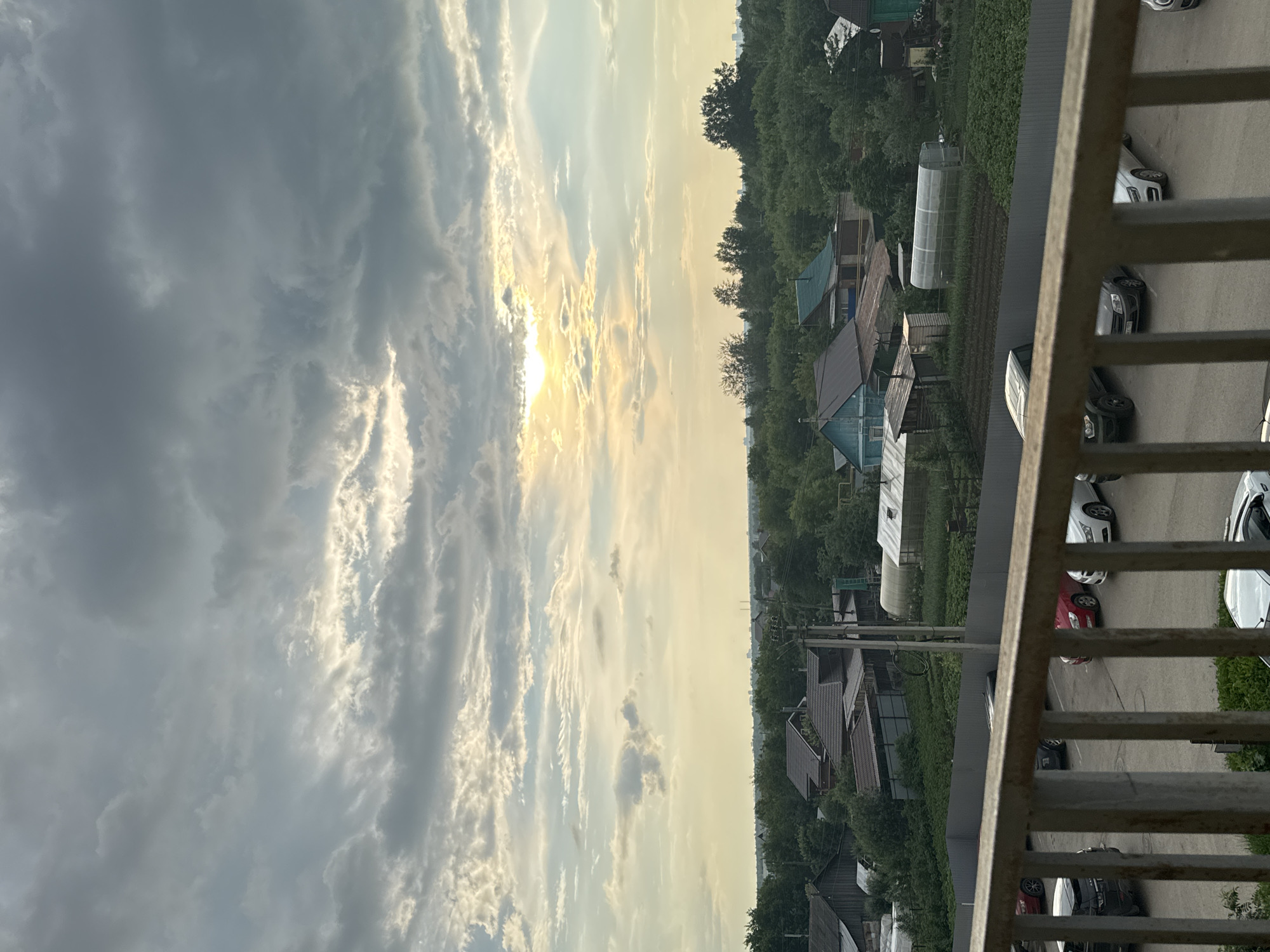 Balcony views of Kondratovo village under dramatic evening skies
