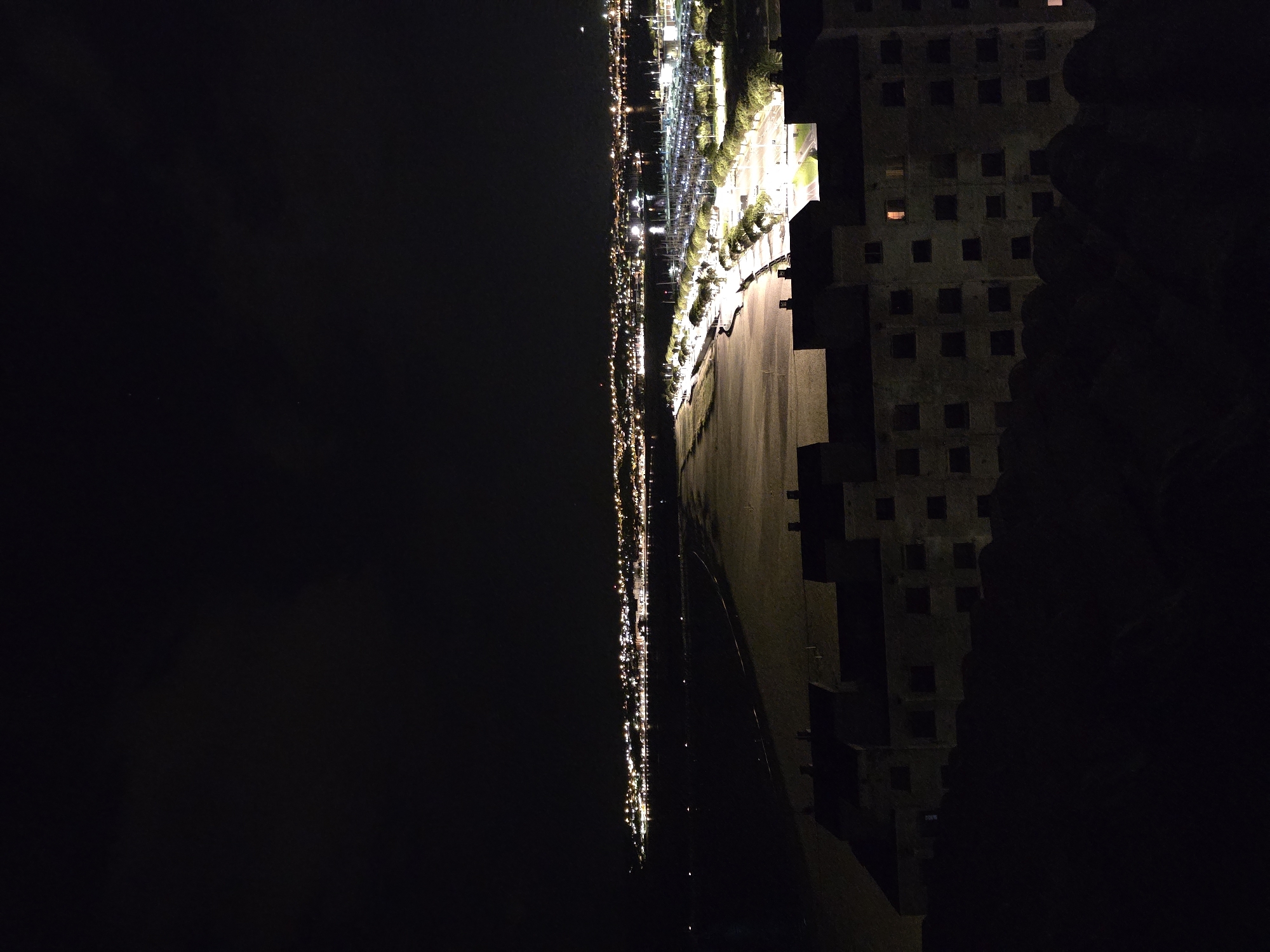 Night view captured of illuminated Hondarribia from elevated vantage point