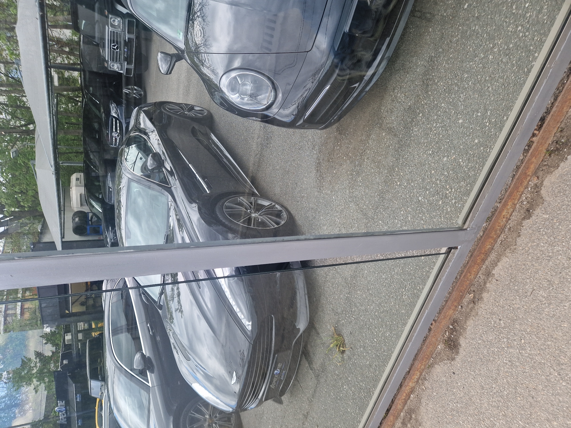 Luxury cars spotted at urban dealership during morning hours
