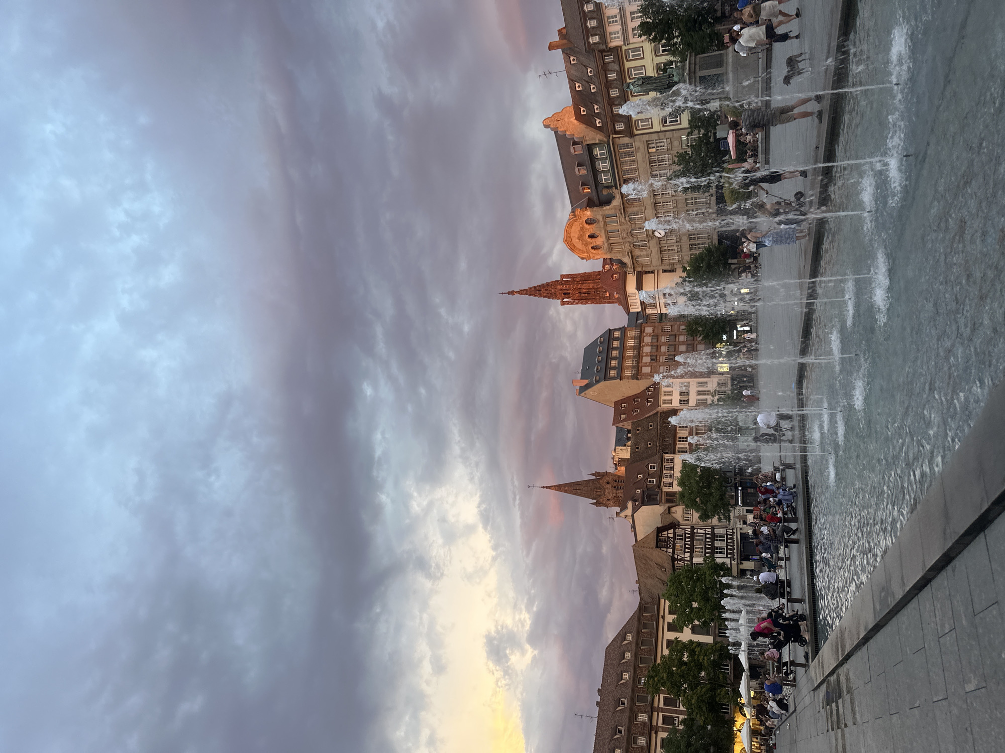 Strasbourg's cathedral square at dusk, fountain running