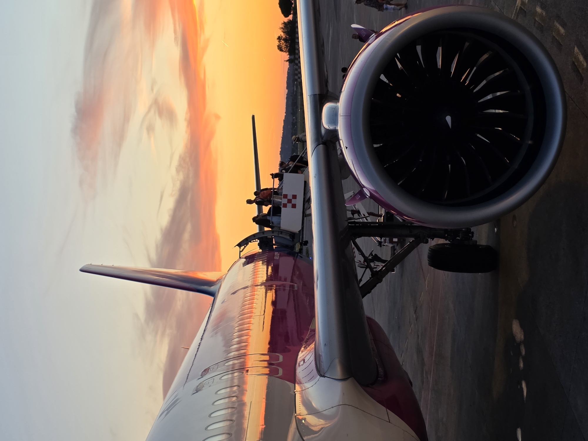 Boarding a passenger jet at sunset on the tarmac