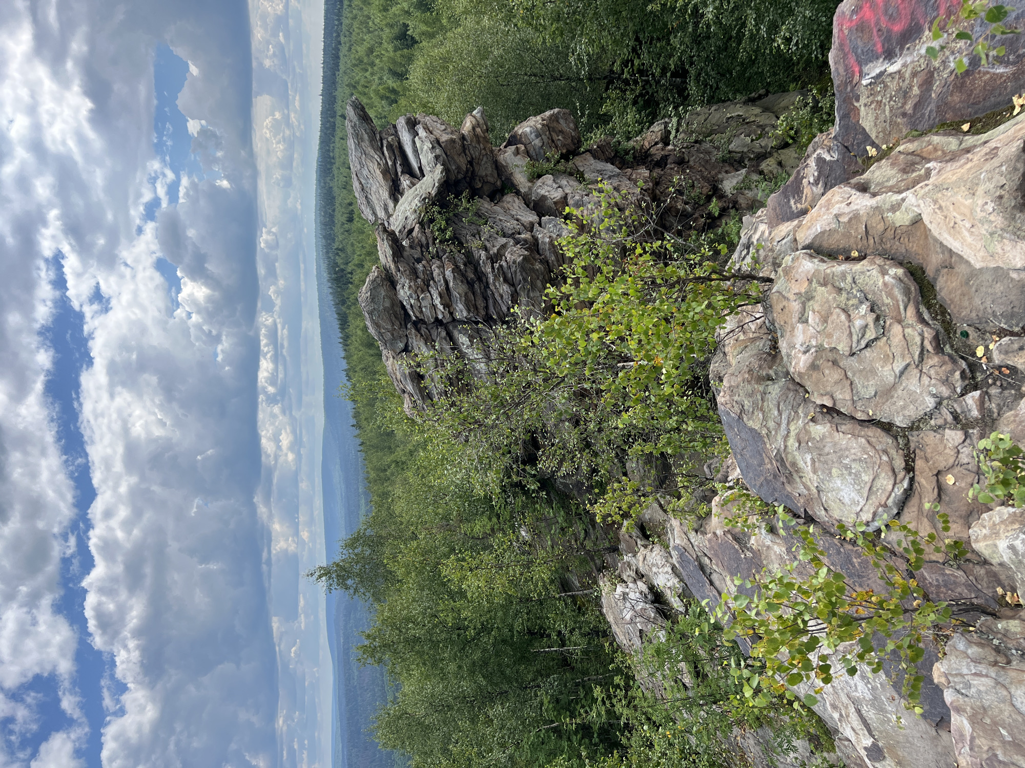 Hiking a marked rocky overlook above Gubakha's forests
