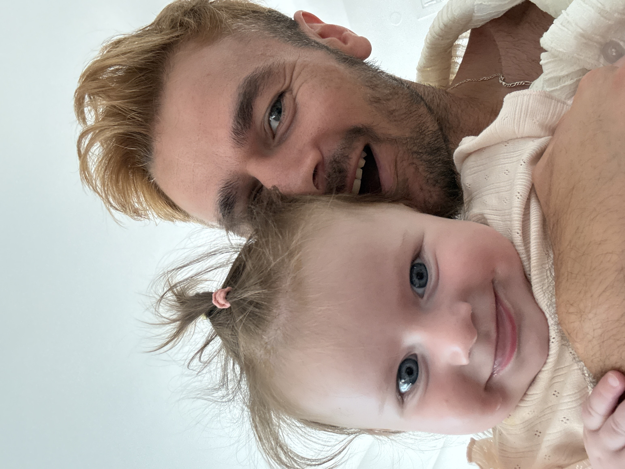 Baby and fluffy dog share a playmat morning in Greece