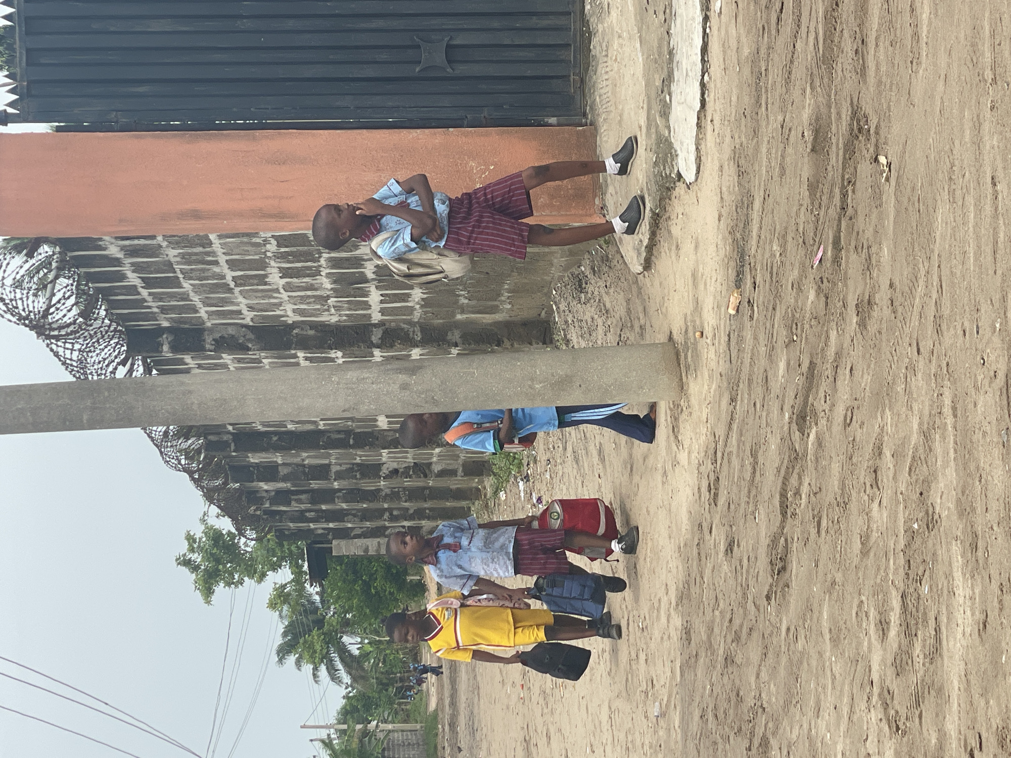School children walk through Badagry streets during afternoon hours