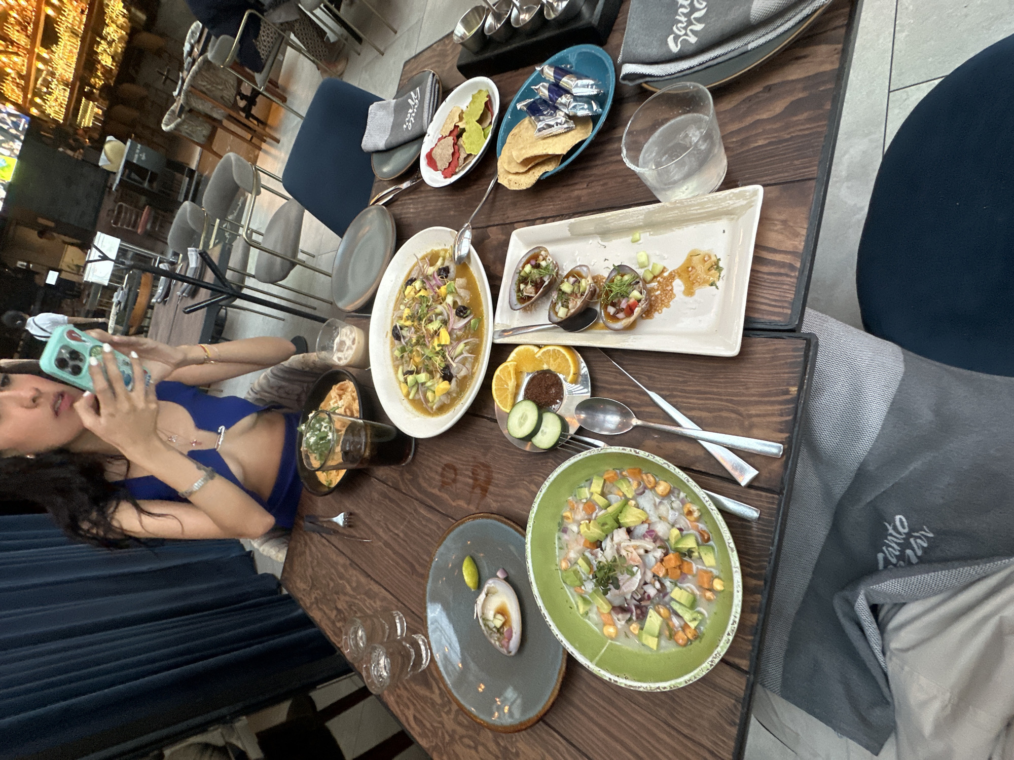 Woman photographs Mexican meal at Querétaro restaurant