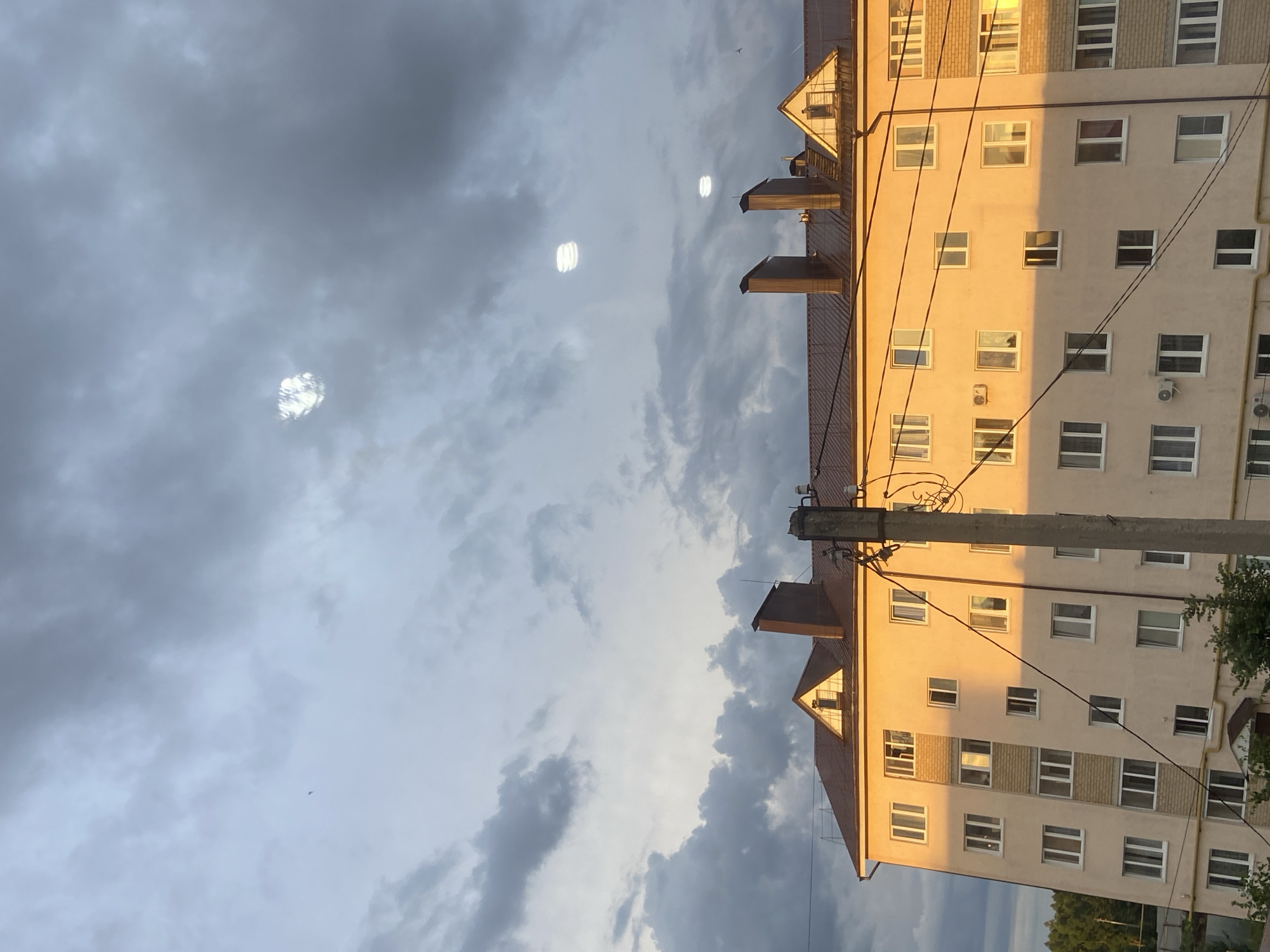 Tujmazy sunset watched across streets, rooftops, and open sky